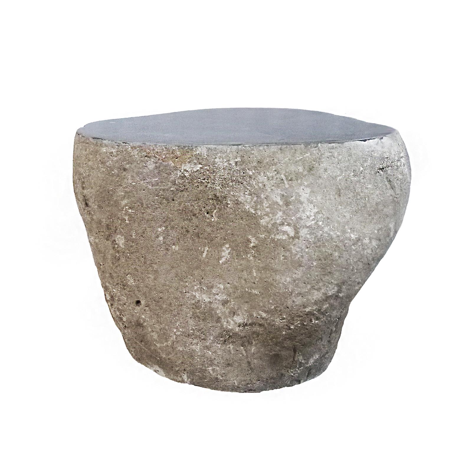 A beautiful solid stone end table, from Indonesia. Contemporary. 
Rustic, unfinished sides with a smoothly polished grey top. Irregular shape, determined by the natural state of the rock.  

23 inches wide, 17 inches deep, 16 inches high. Ideal for
