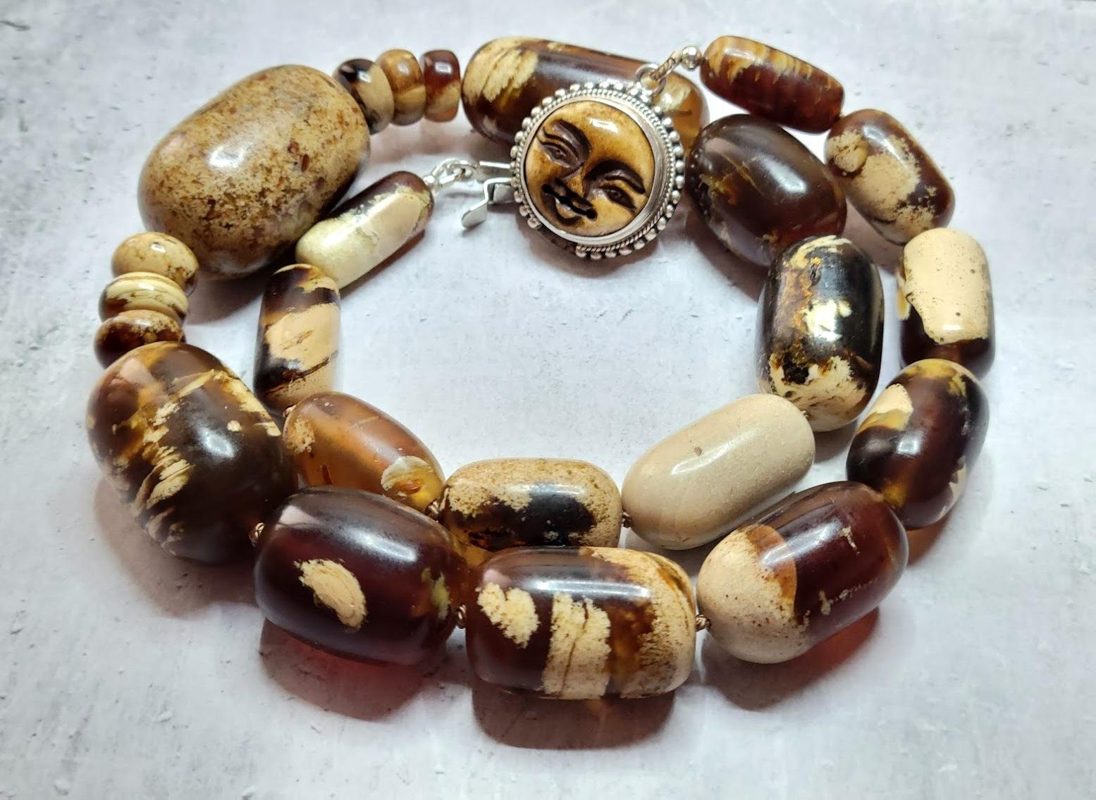 The length of the necklace is 22 inches (56 cm). The size of the huge smooth barrel beads varies from 22 mm to 37 mm.
The color of beads varies from light beige to saturated brown. In bright sunlight, the Sumatran amber has a shade of blue.
The
