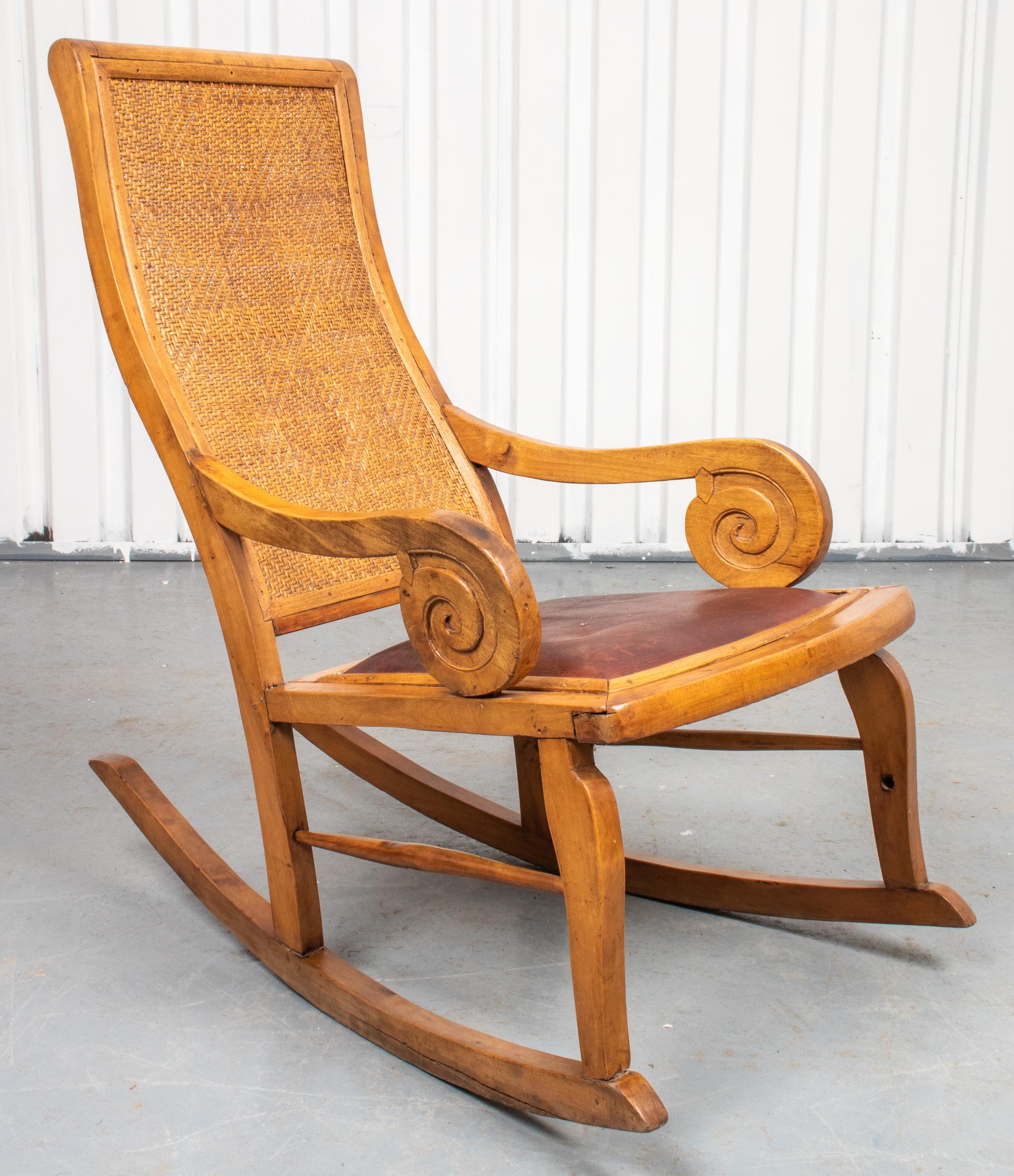 Indonesian Teak plantation rocking chair with leather seat. 37” H x 22” W x 40.5” D x Seat 19