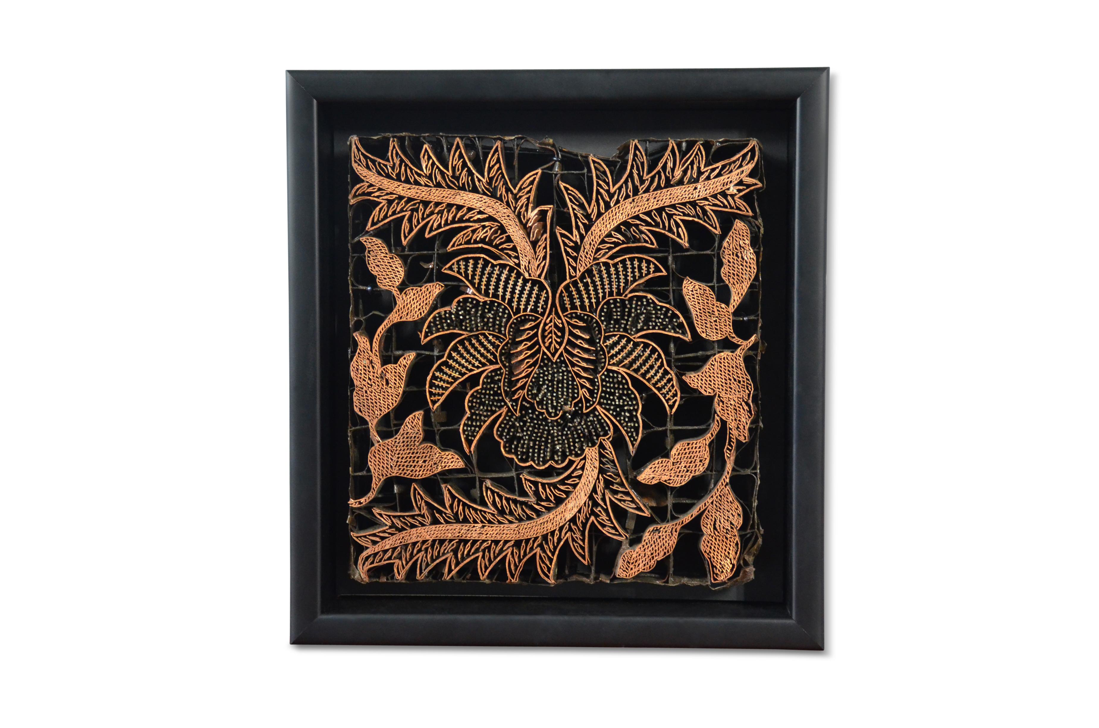A vintage Indonesian copper Batik textile printing block from the mid 20th century, mounted in a black shadow box. Created in Indonesia, this copper stamp was used by Batik artists to create ornate motifs by dipping it in hot wax and applying it on