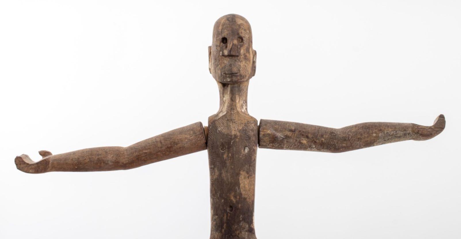 Indonesian Wood Patung Polisi Guardian Sculpture, 19th century, West Borneo, depicting a standing male figure with arms outstretched, smiling face, on original wood base with floral carving and mounted to metal base. 33