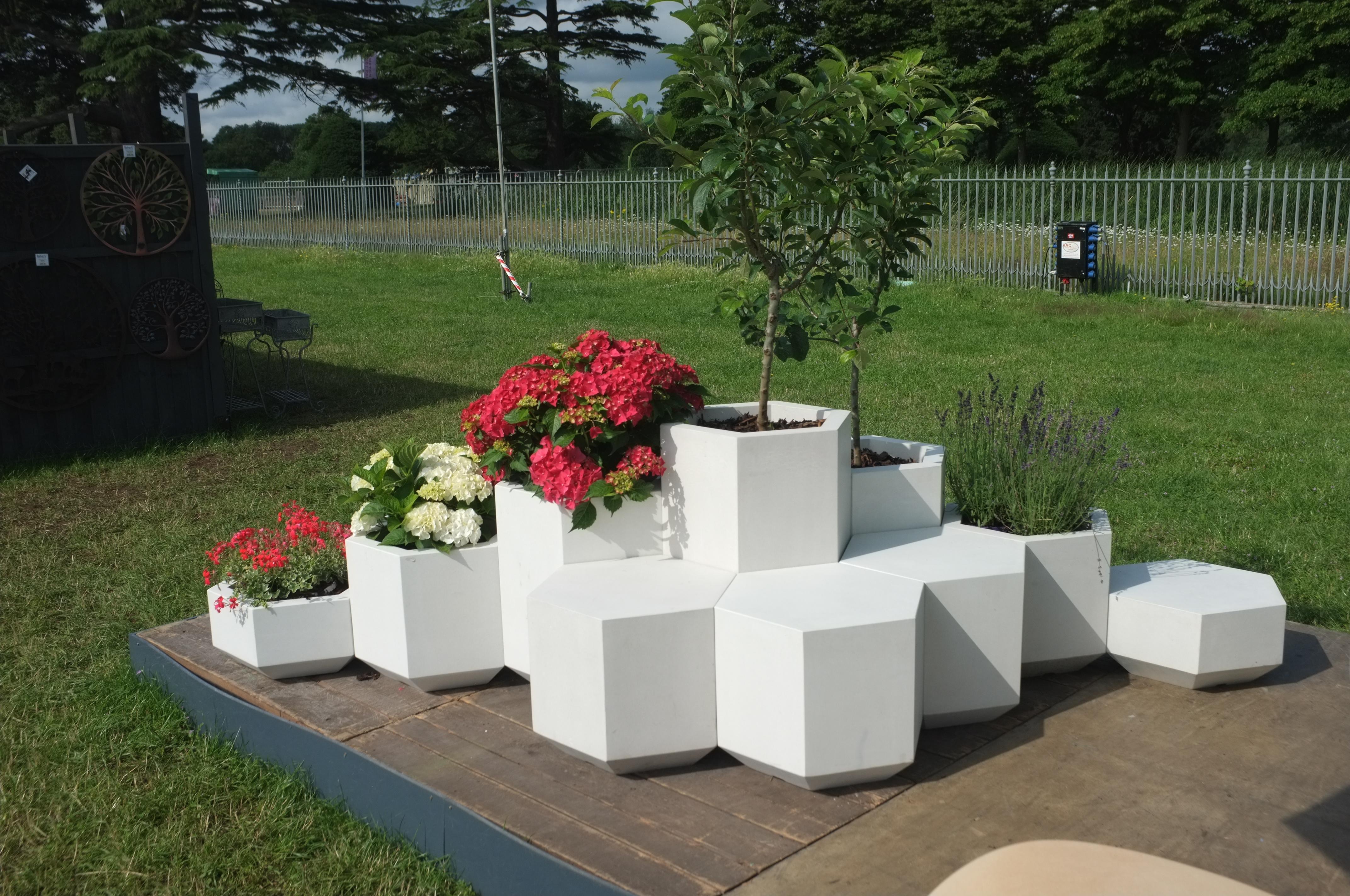 The Hex-block planter is a perfect hexagon. This simple geometric shape is handcrafted to survive outside in the harshest weather, but with its tactile smooth concrete finish it works just as well as an interior piece of furniture. Measure: 58