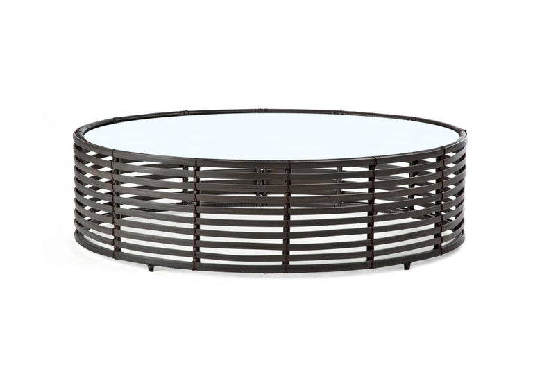 Indoor large oval Lolah coffee table by Kenneth Cobonpue
Materials: Nylon, steel, rattan. Glass.
Also available in other colors and for outdoors.
Dimensions: 
Glass 78cm x 118cm x H 10mm
Table 80cm x 120 cm x H 35 cm


Created using