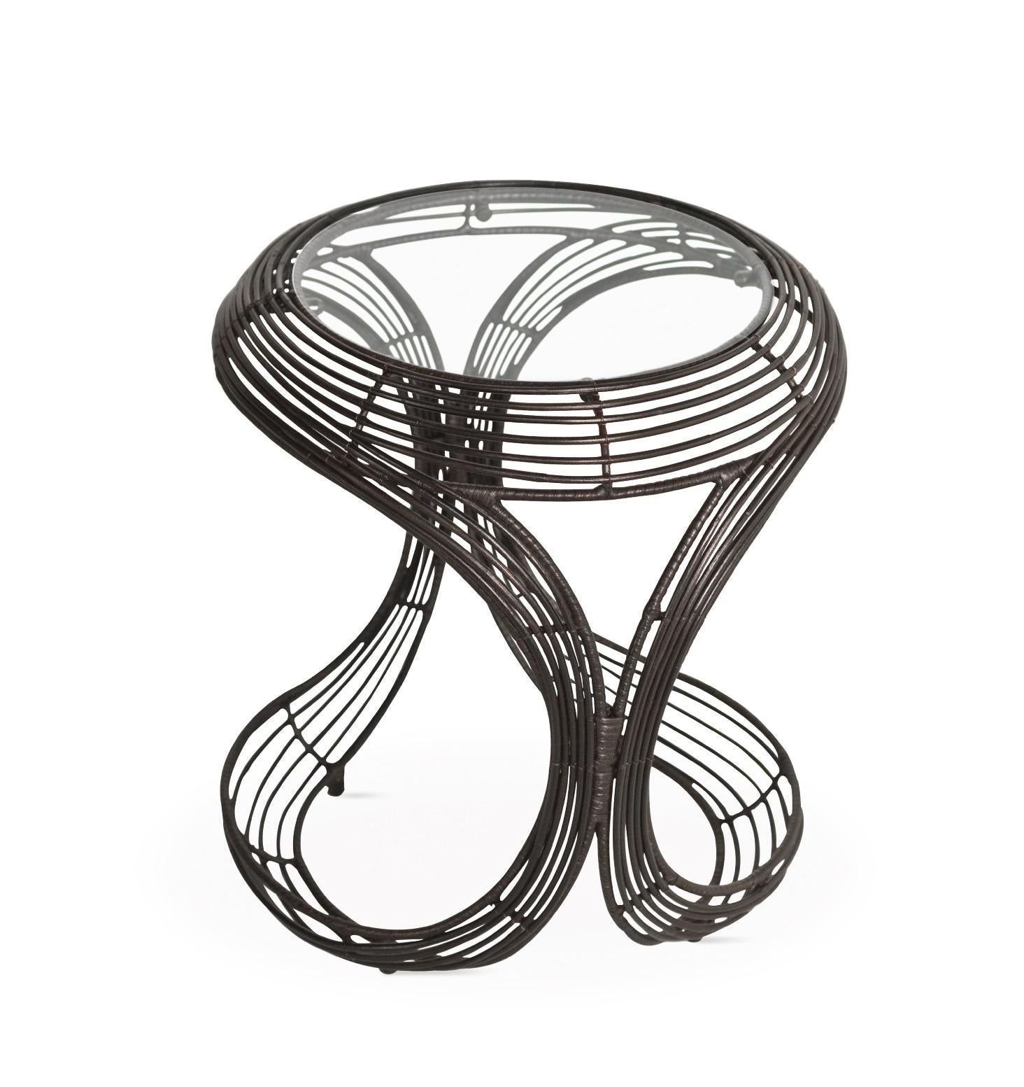 Indoor Manolo end table by Kenneth Cobonpue
Materials: Rattan, Nylon, Steel, Glass.
Also available in other colors and for outdoors. 
Dimensions: 
Glass Diameter 31.5 cm x H 6mm 
Table 45 cm x 50 cm x H 50 cm

Taking inspiration from the