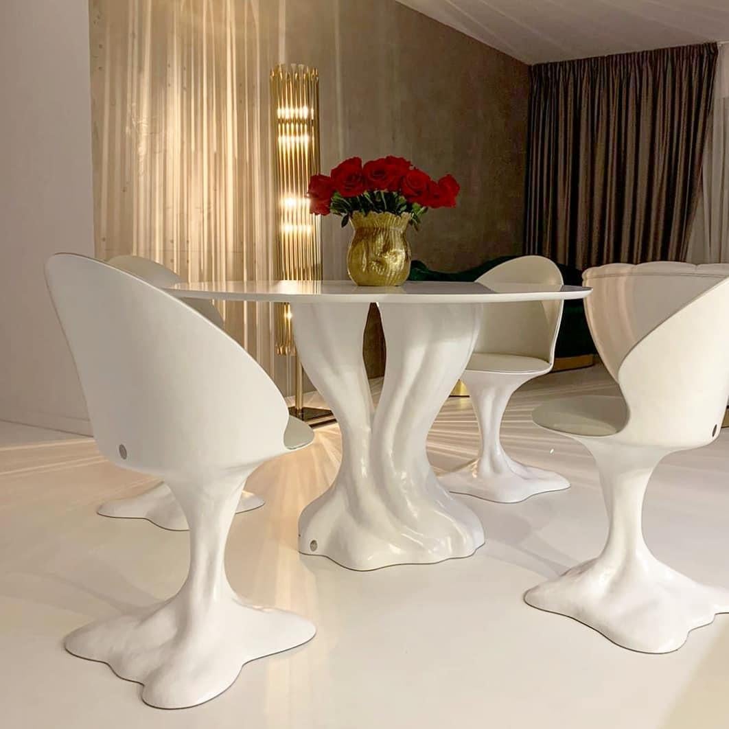 Introducing our 5-piece indoor/outdoor dining table and chairs crafted from fiber-reinforced resin, providing unparalleled durability and longevity. Available in a sleek lacquered matte white finish, or choose from a selection of lacquer colors to
