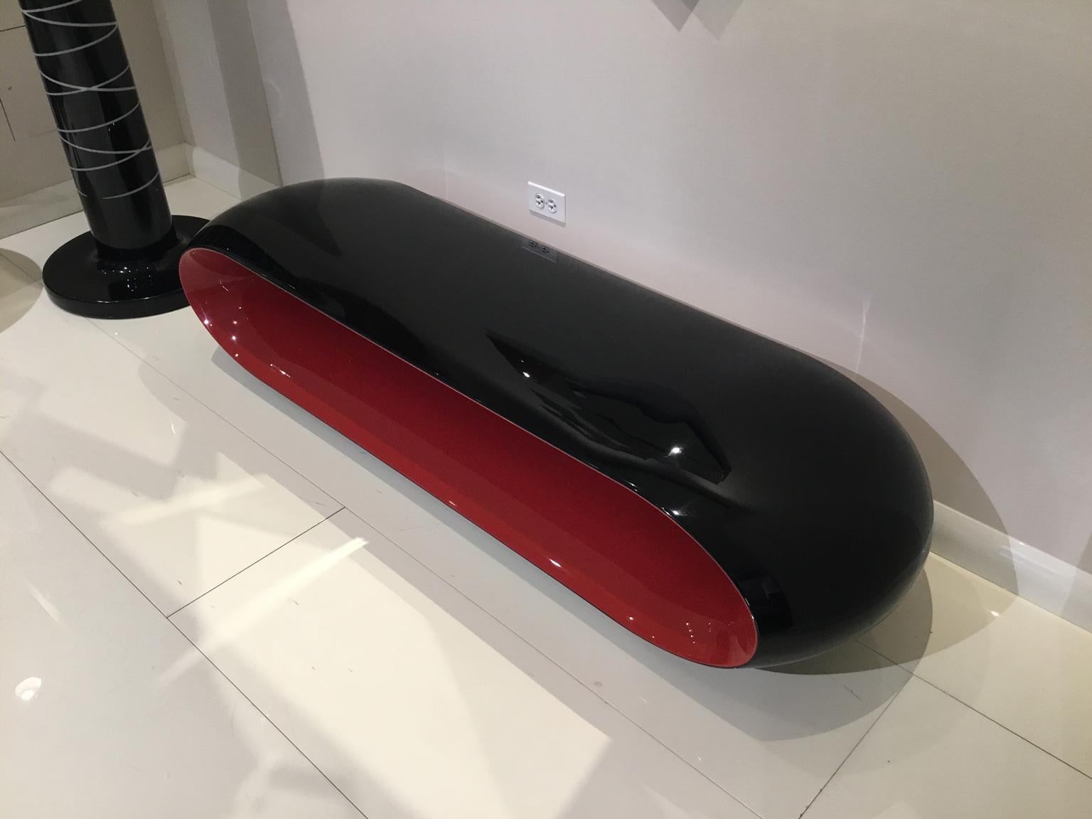 Loop bench by Christophe Pillet for Serralunga.

Indoor / outdoor bench in glossy black and red lacquer. Frame in LLDPE (linear low-density polyethylene). 

Dimensions:

180cm W x 50cm D x 40cm H
71