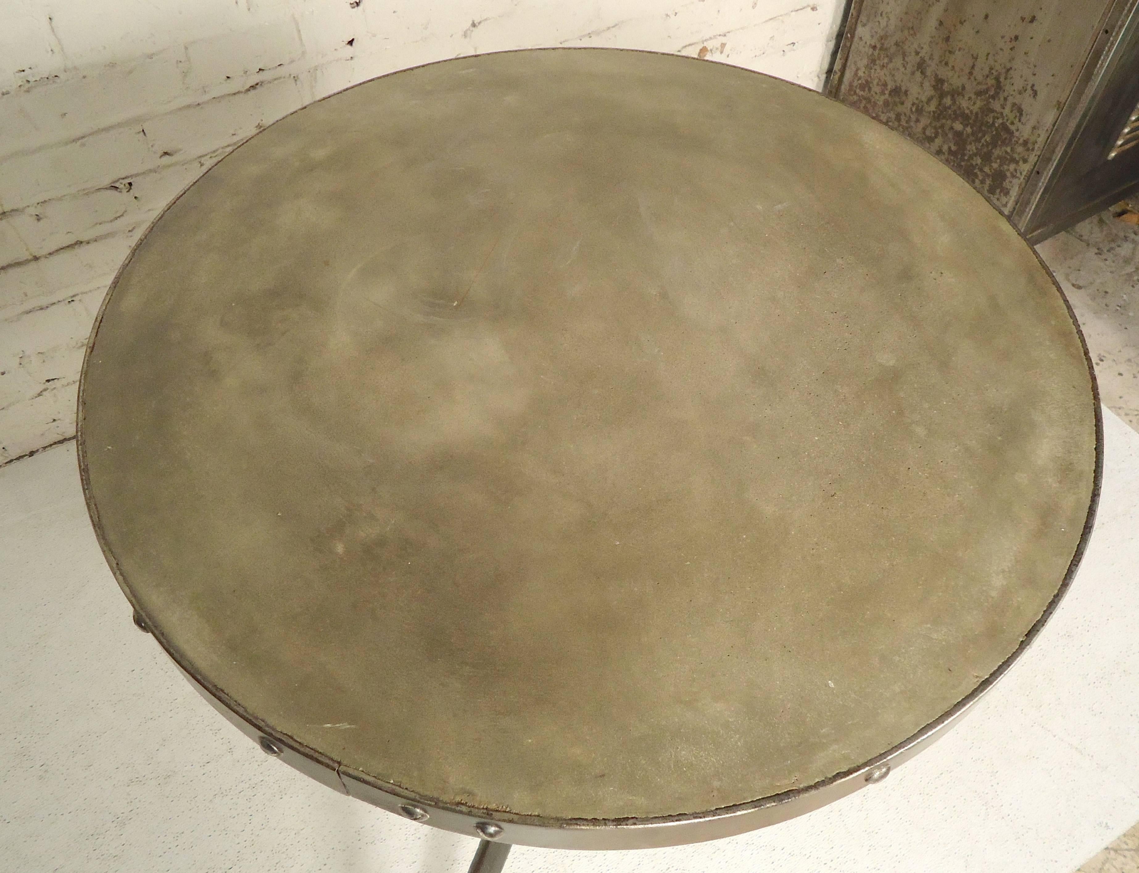 Small round patio table with concrete top and heavy metal frame. Frame has been refinished to a bare metal style finish.

(Please confirm item location - NY or NJ - with dealer).
 