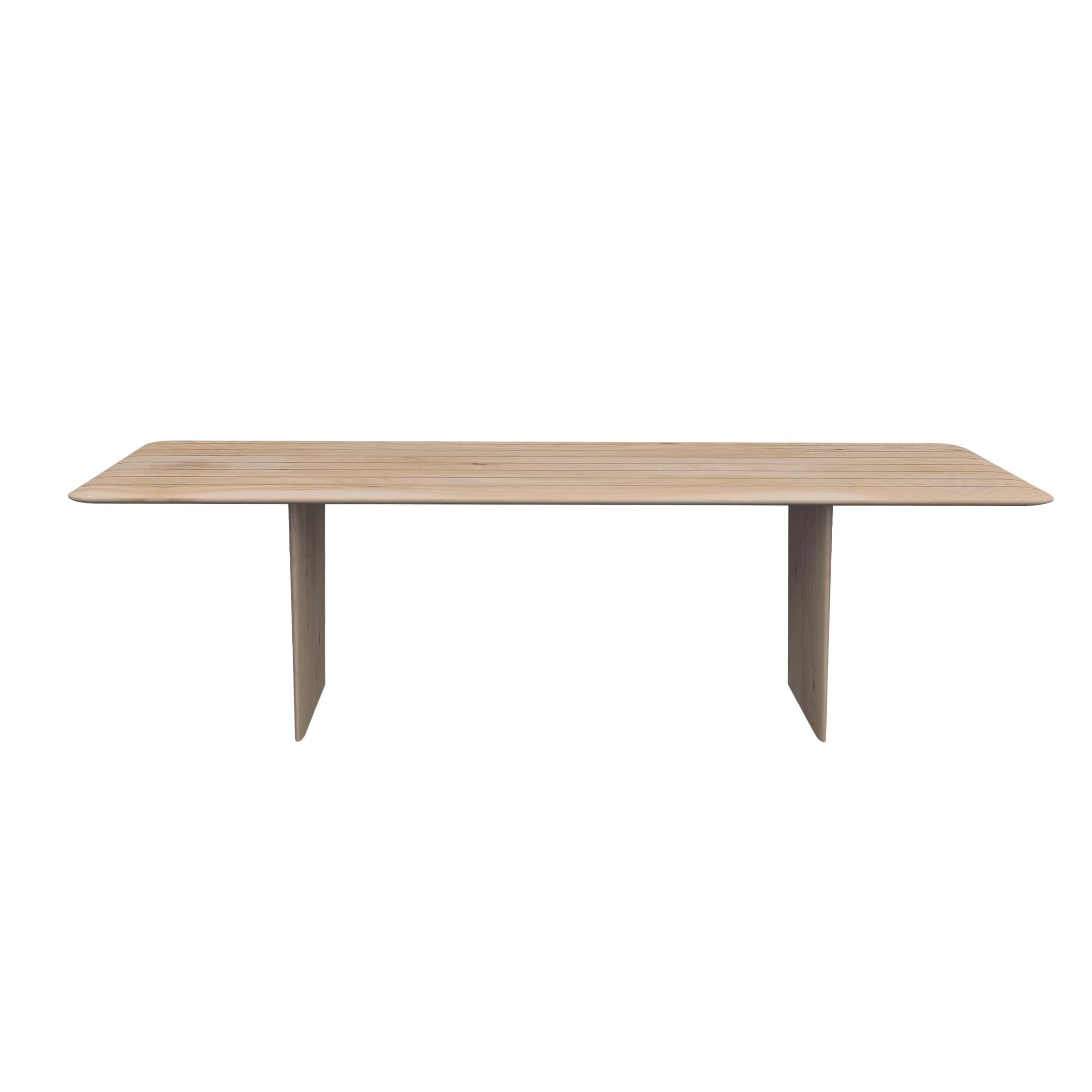 Crafted entirely from solid scented cedar wood, this table features rounded sides and thin, beveled edges on both the top and legs, lending it a delicate and sinuous design. Its lightness is accentuated by the thoughtful use of rounded edges