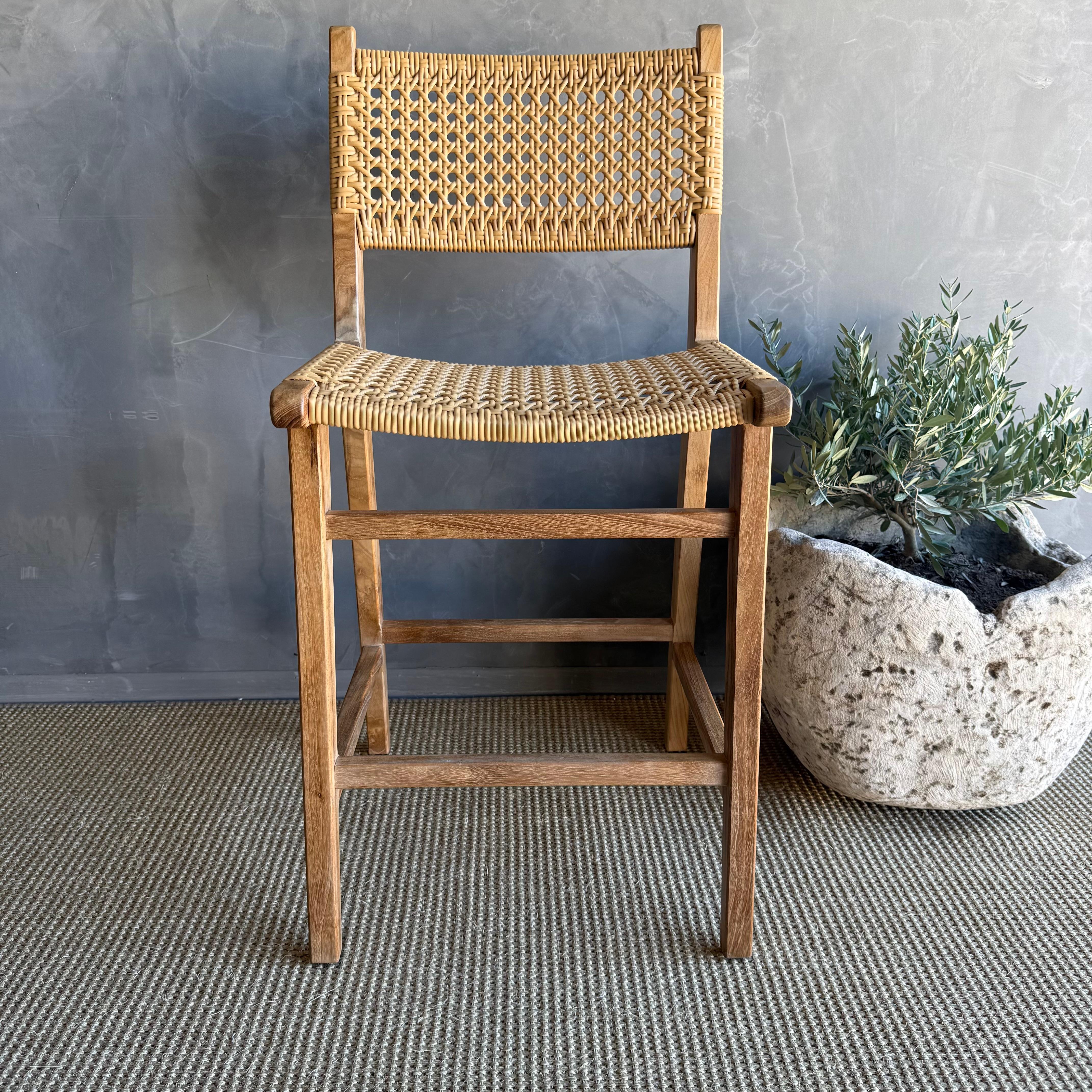 Enhance your indoor / outdoor dining experience with this stylish solid teak wood counter stool featuring a wipeable woven seat and back. Crafted from high-quality teak wood, this counter stool offers durability and timeless elegance. 
Whether