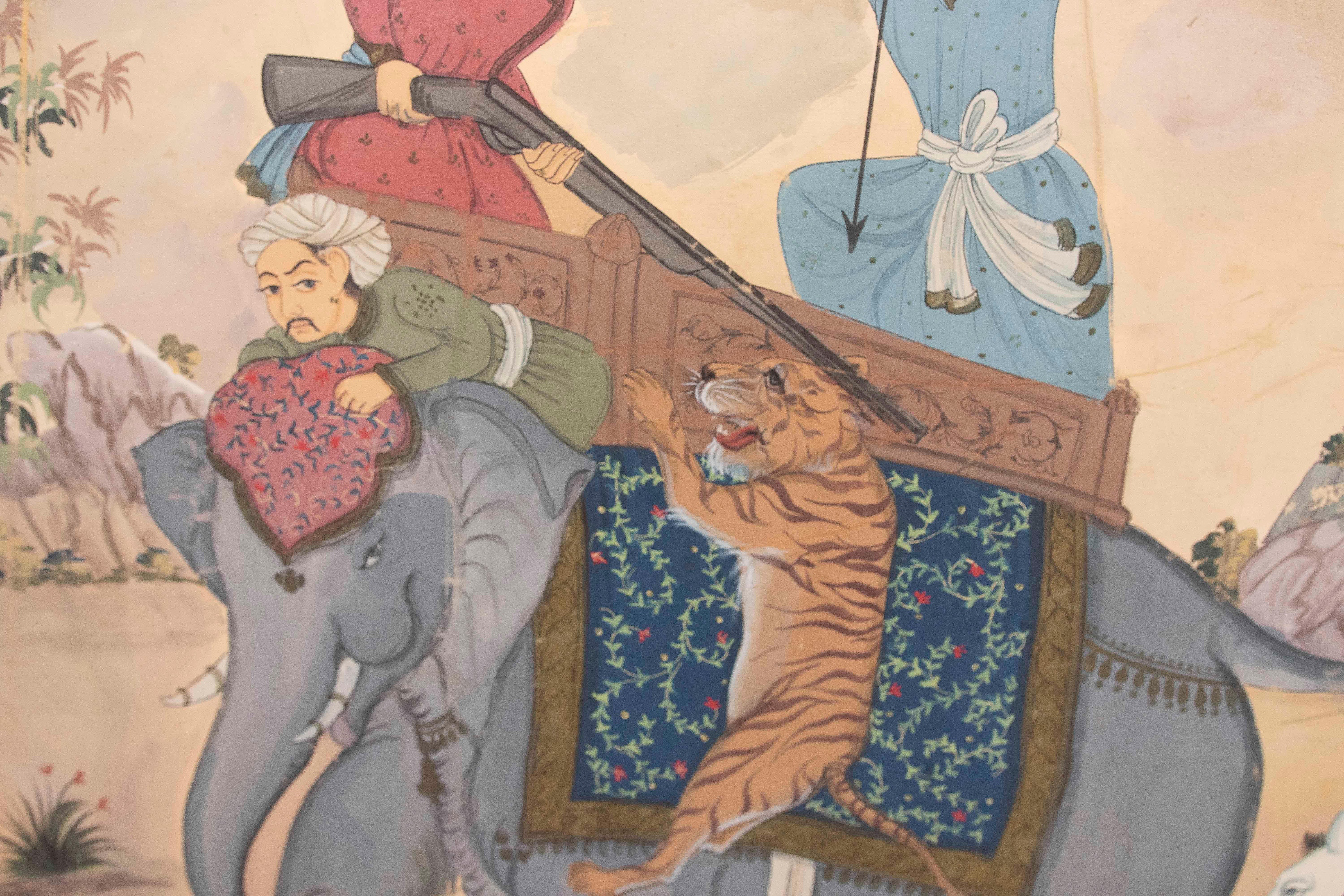 Indien Peinture de chasse d'un tigre avec un éléphant et des ornements chantournés bordant la scène en vente
