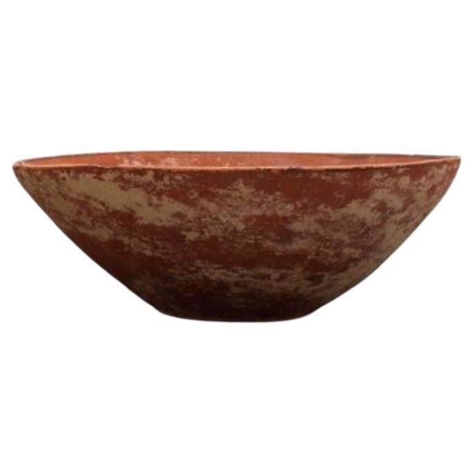 Ca. 3000-2500 BC A terracotta bowl from the Indus Valley in a  substantial size and flaring, deep body resting upon a low ring base. While the exterior surface remains impeccably smooth and devoid of ornamentation, the interior unveils an