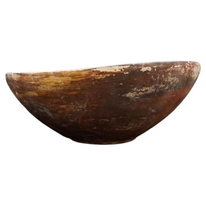 Ca. 3000-2500 BC. A fine terracotta bowl from Indus Valley, featuring a flaring body leading to a wide mouth. The bowl sits on a subtle ring foot. The interior is embellished with a decorative border of curvilinear motifs around the rim, and sets of