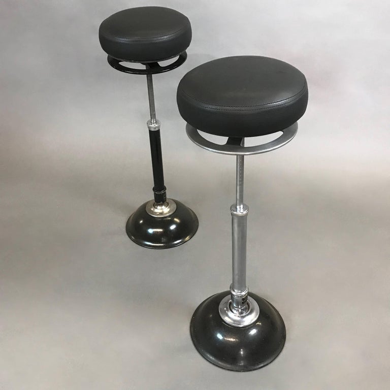 Industrial, dentist, medical stool by Ritter Mobilrest features an articulating, chrome pedestal stem that pivots within the ball joint of the weighted, painted cast iron base and porcelain, quick release lever to adjust the height, under the newly