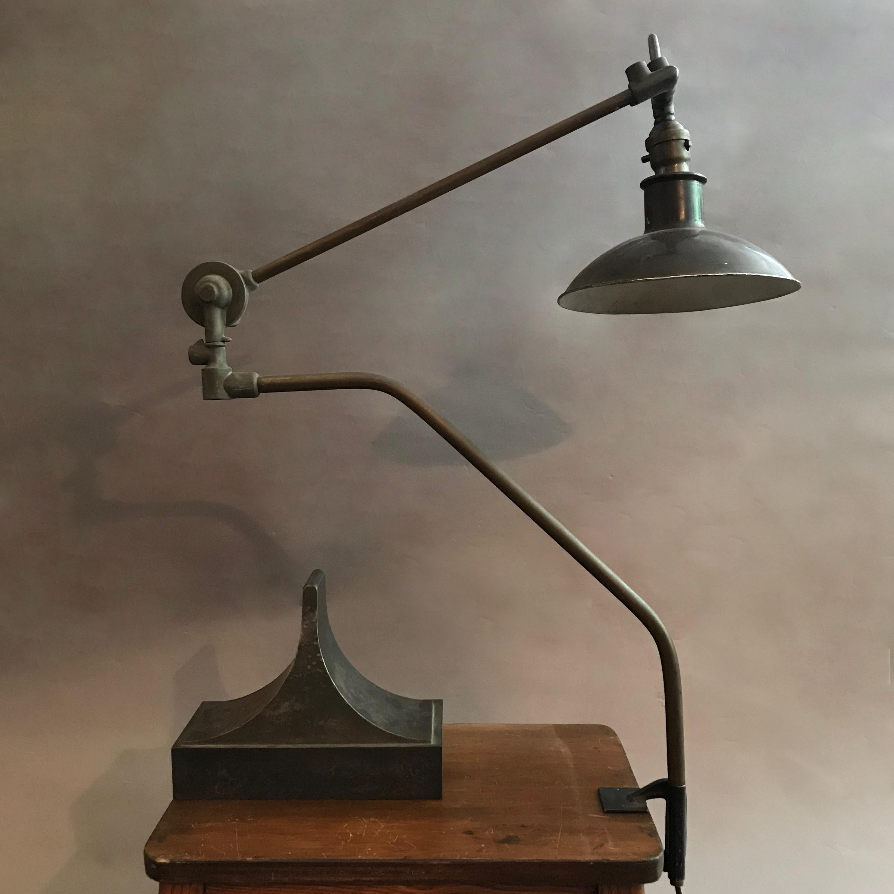 Outstanding, early 20th century, brass and metal task, work lamp signed Malleable pivots 360 degrees at it's base and top hinge where the height can be adjusted as well. The lamp shows incredible patina and elegant lines.