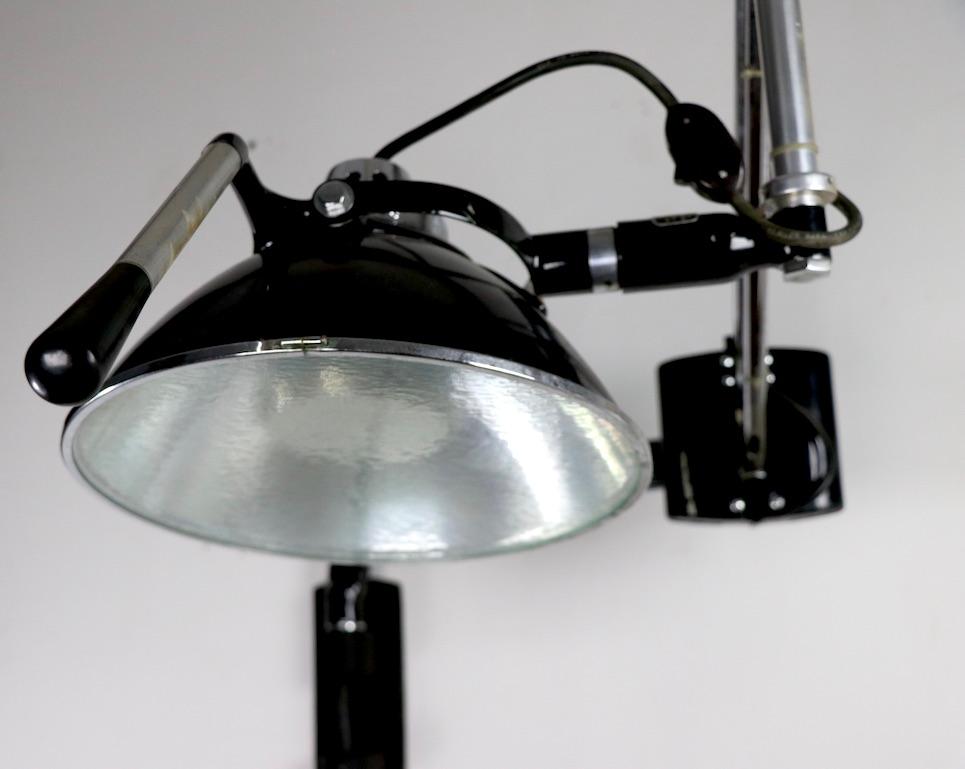 Excellent Industrial style wall mount flex arm wall light, by Wilmont - Castle Co. circa 1950s. This example has two arms , the black arm being 12.5 inch x chrome arm 25 inch x 13 D of shade inch. Backplate 10 H x 4 W x 3 D inch. The arm will extend