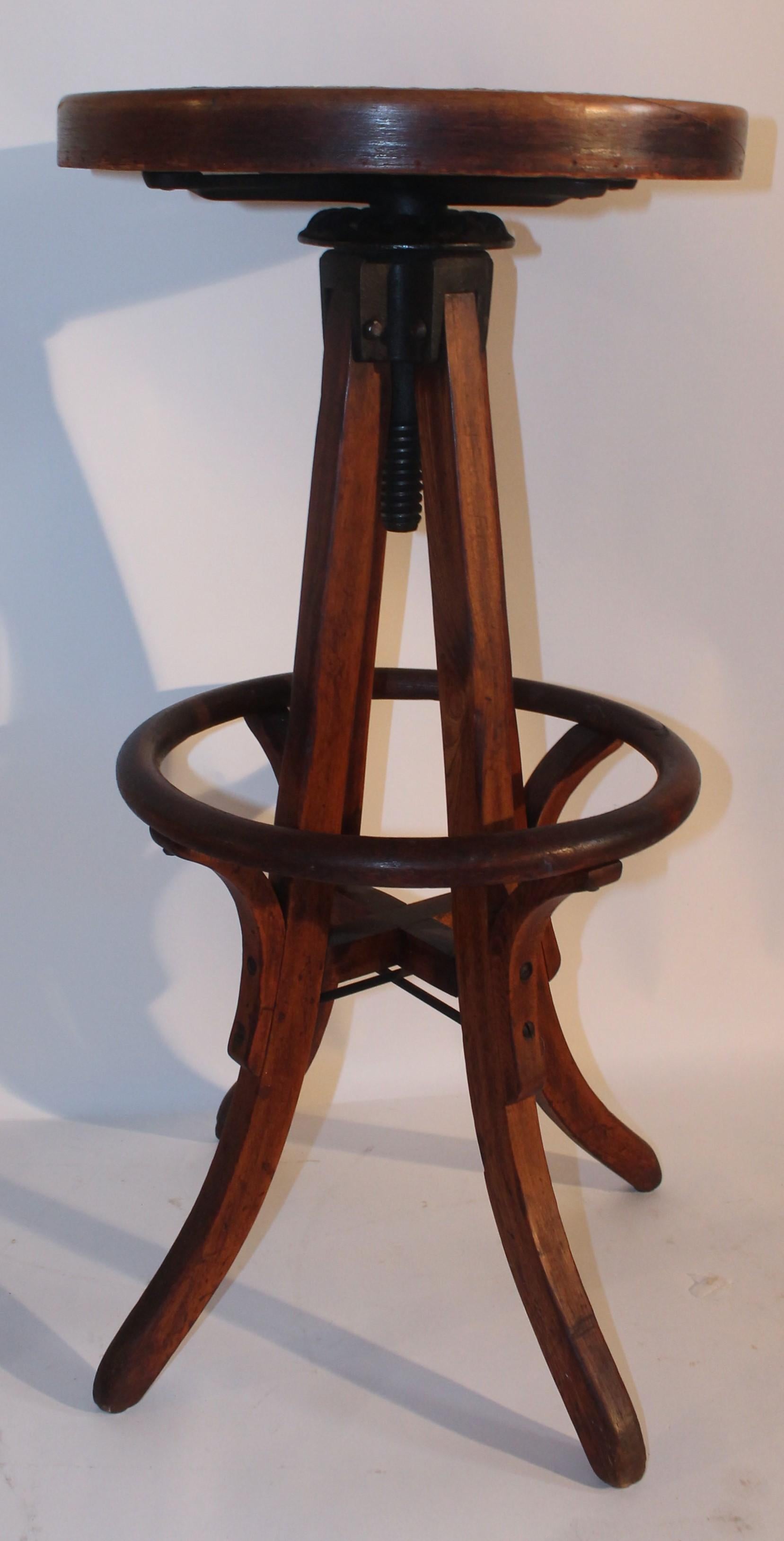 This fine bentwood bar stool with cane seat and in fine condition. The stool swivels and has all the original iron hardware. The iron has all original black paint and is in fine working condition.