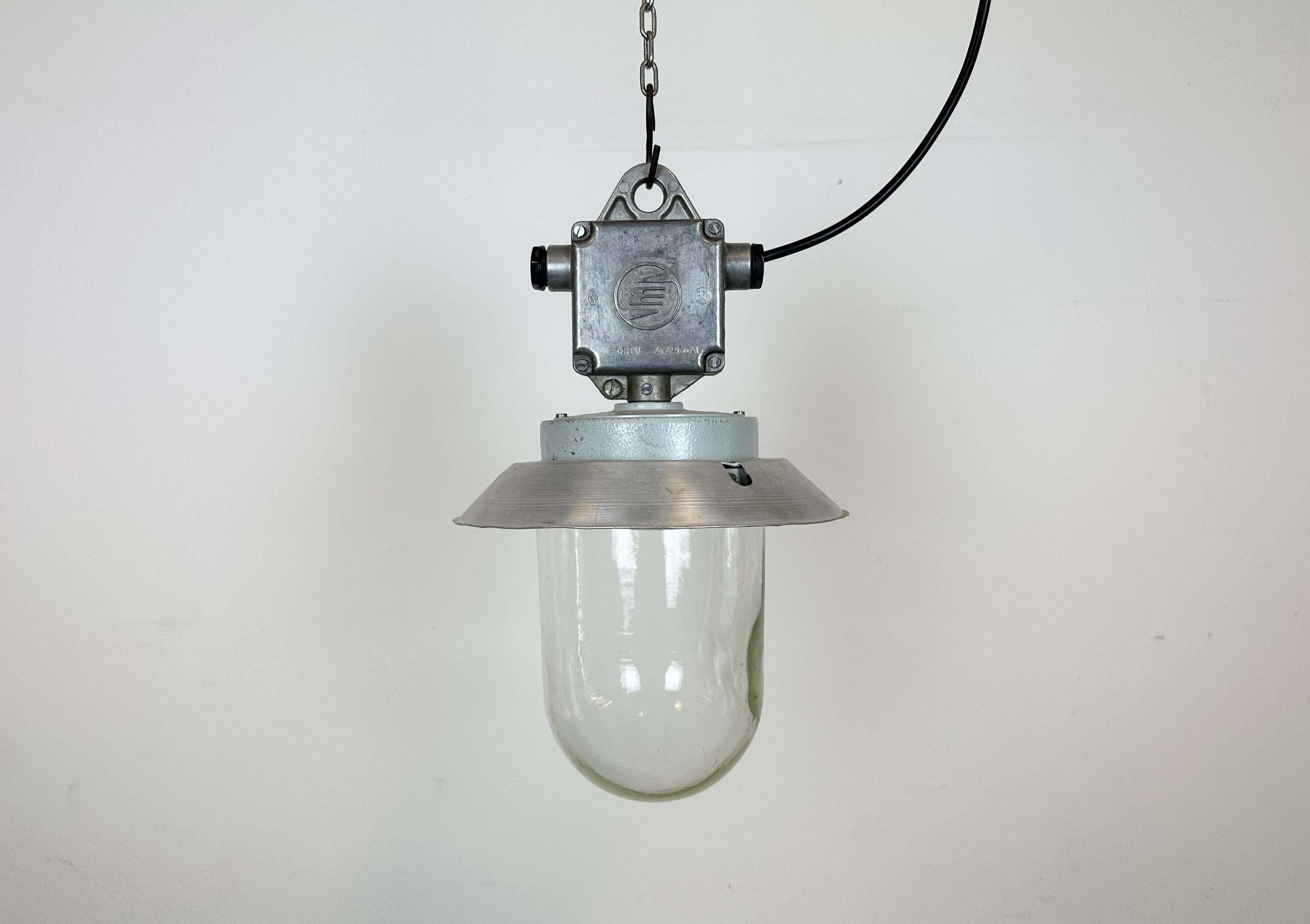 This Industrial wall light was made by Elektrosvit in former Czechoslovakia during the 1970s. It features a cast aluminium top, an aluminium shade and a clear glass cover. New porcelain socket requires standard E 27/ E26 light bulbs. New wire. The