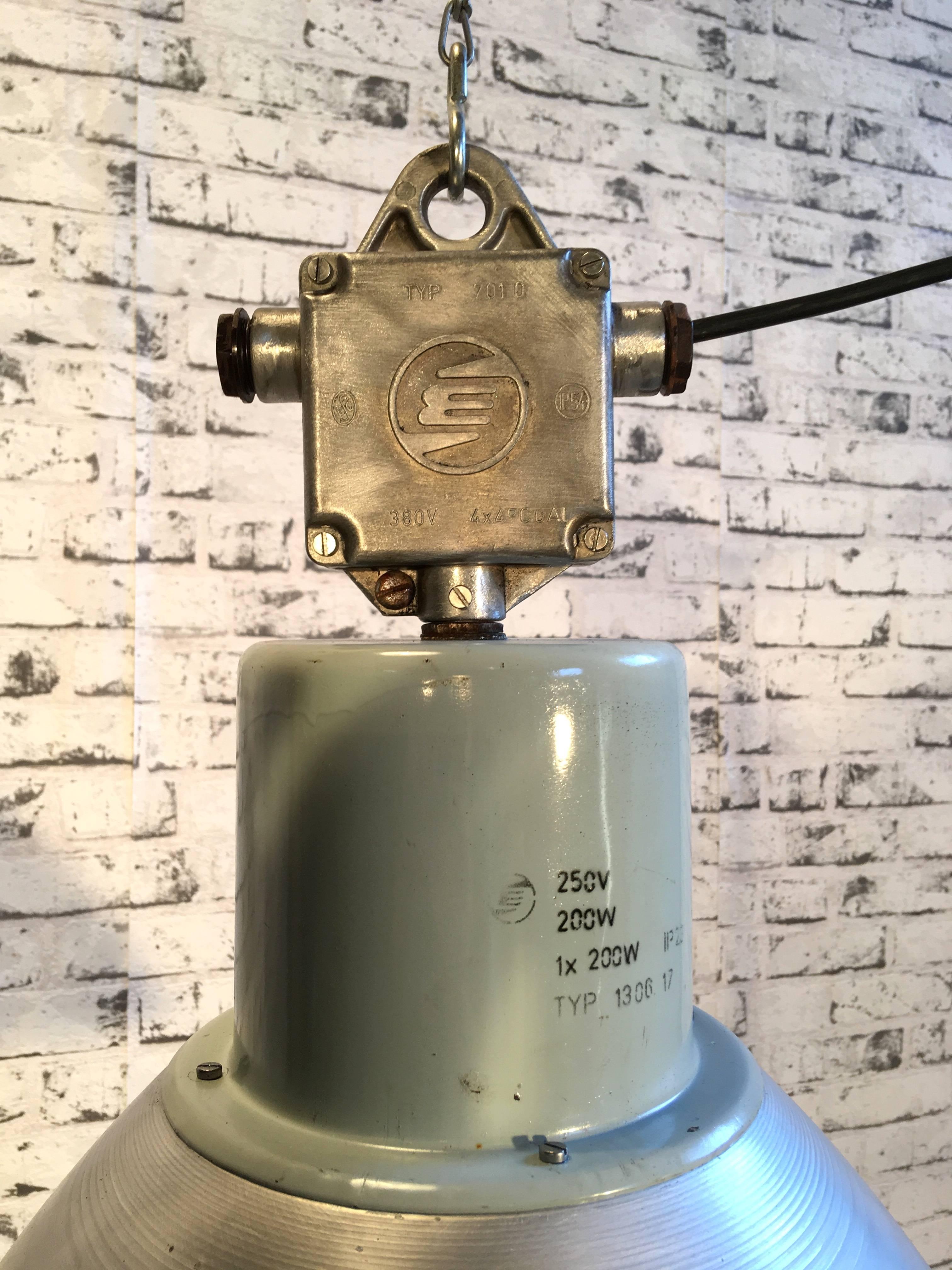 This pendant lamp was used in a factory in former Czechoslovakia in the 1960s. It features a aluminum lampshade and cast aluminum top. Lamp is fully functional, has new porcelain socket for E27 ligtbulbs and wire.
Weight of the lamp is 2.5 kg.