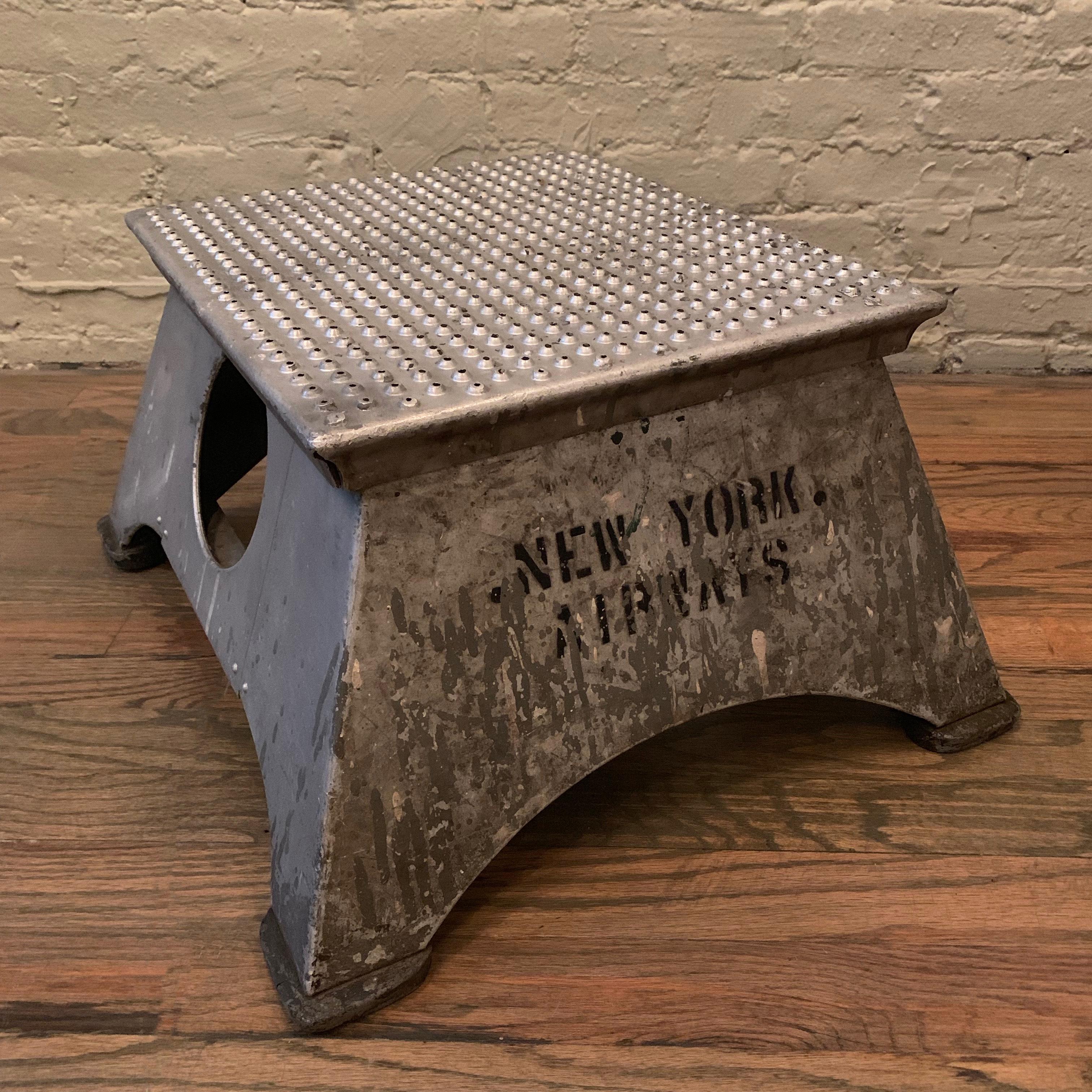 Industrial, aluminum, airplane step stool features the stamp New York Airways, (1949-1968) on one side, a perforated top and rubber glides with all original, work-worn patina. It's a piece of New York aviation history.

New York Airways was a