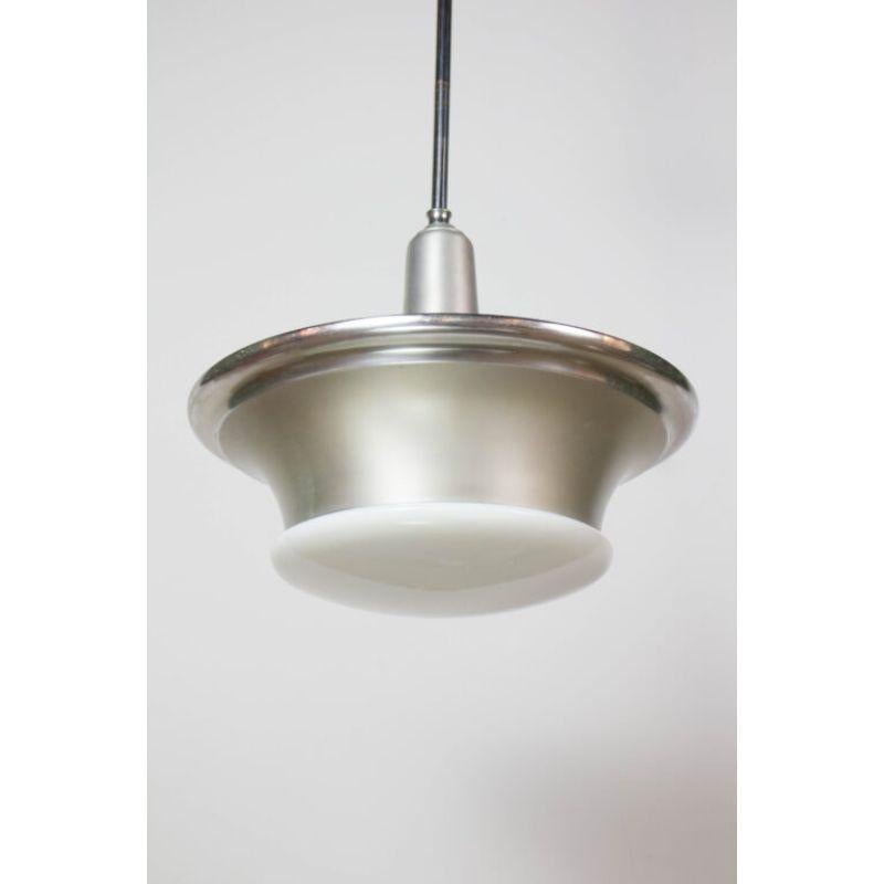 Industrial aluminum and glass pendants. Original blown glass shades, with sailor hat style shade rings. American, C. 1930

Dimensions: 
Height: 34?
Diameter: 18?.