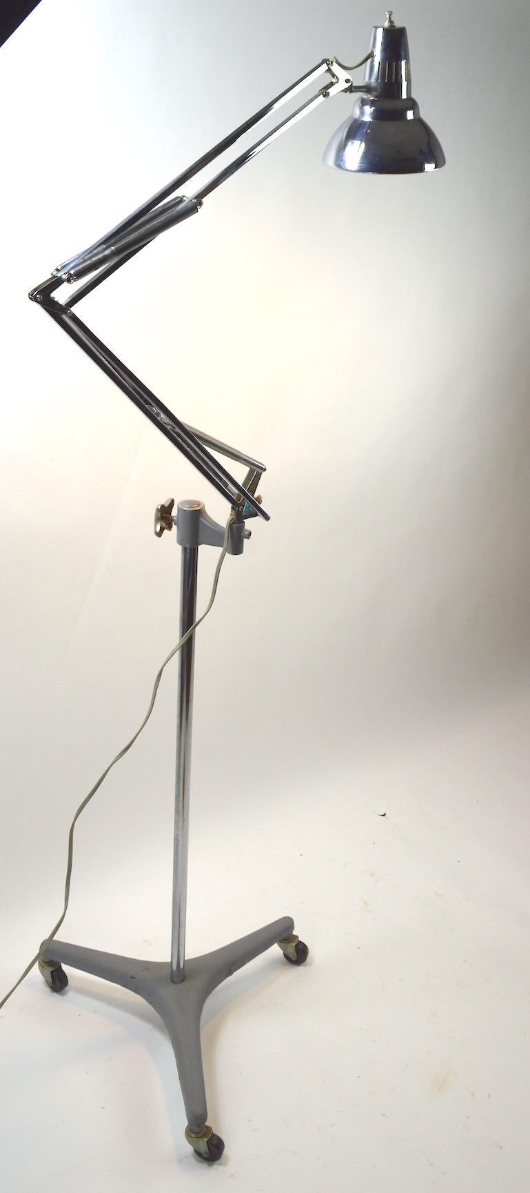 Superb example in great, original, and working condition. Jac Jacobsen design for Luxo adjustable floor lamp. Model L-1 with chrome arms vertical pole, and head, on grey cast iron tri pod base. This lamp has many articulations, to position the light