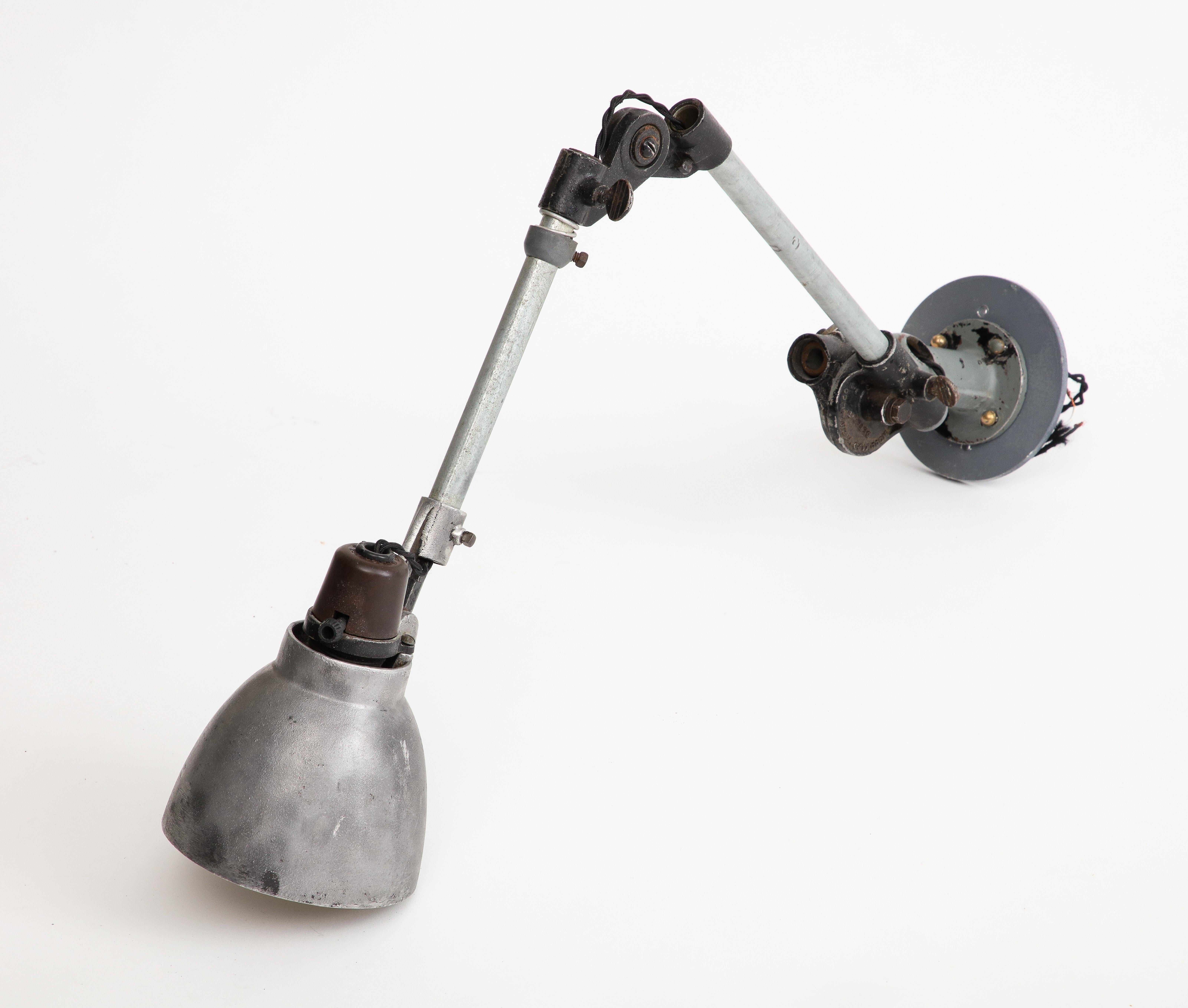 Industrial Anglepoise wall-mounted cast iron sconce, c. 1940. 

The Anglepoise lamp is a balanced-arm lamp designed in 1932 by British designer George Carwardine. 

33