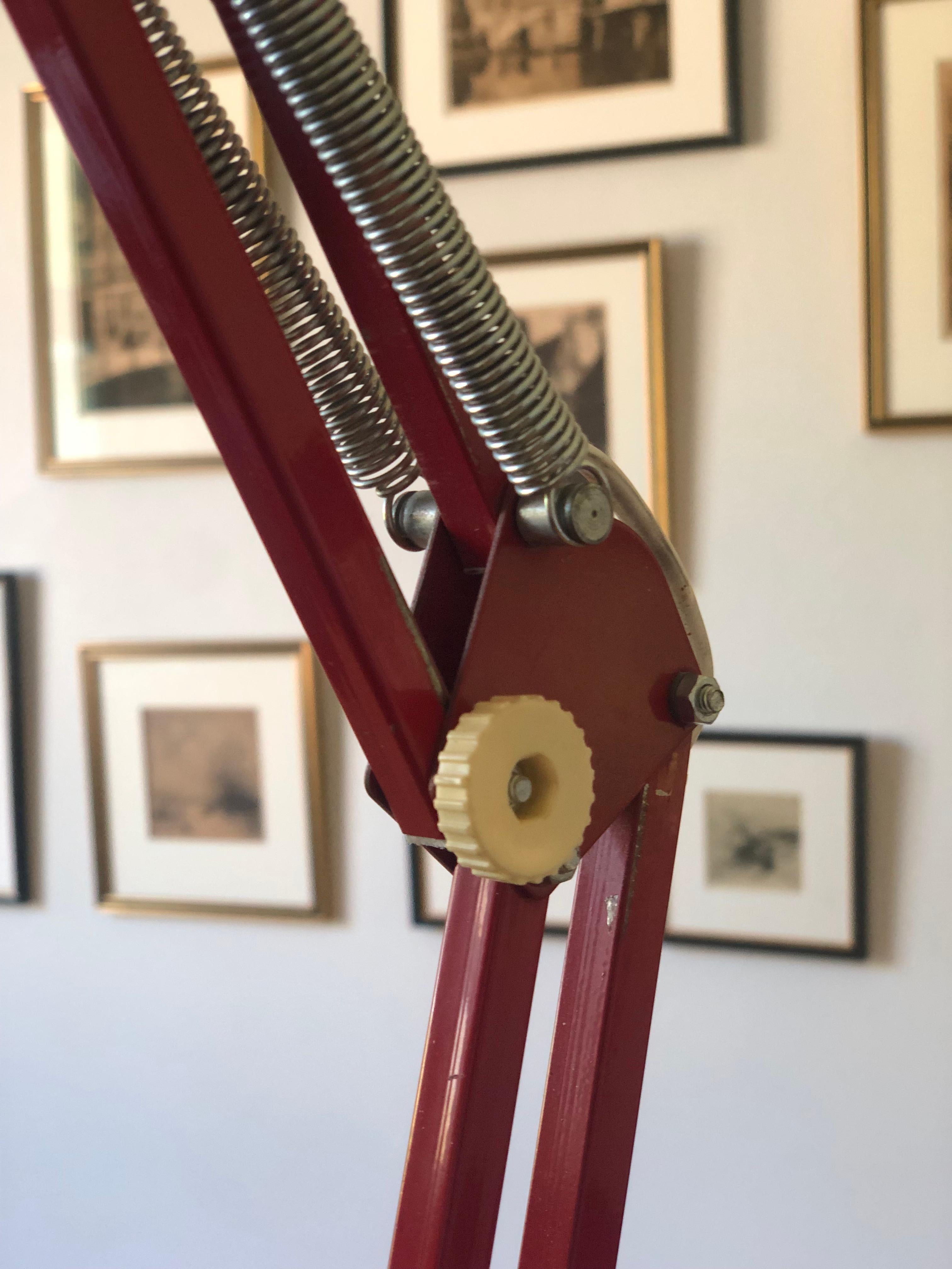 A vintage Scandinavian red architect lamp from the 1970s, designed by HCF Denmark for the Fysisk-Kemisk Institut in Copenhagen. This industrial desk lamp clamps onto the side of a table and can rotate 360 degrees. It has three pivot points for