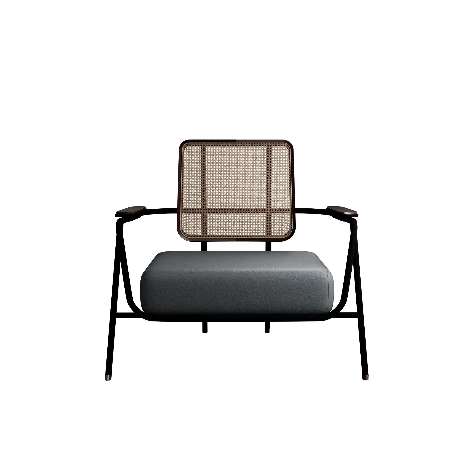 Murmurio's armchair with arm DUV sturdy iron structure provides a solid foundation, while the intricately woven rattan backrest, supported by an ashwood frame, adds a touch of natural beauty. The seat is upholstered in genuine leather, offering both