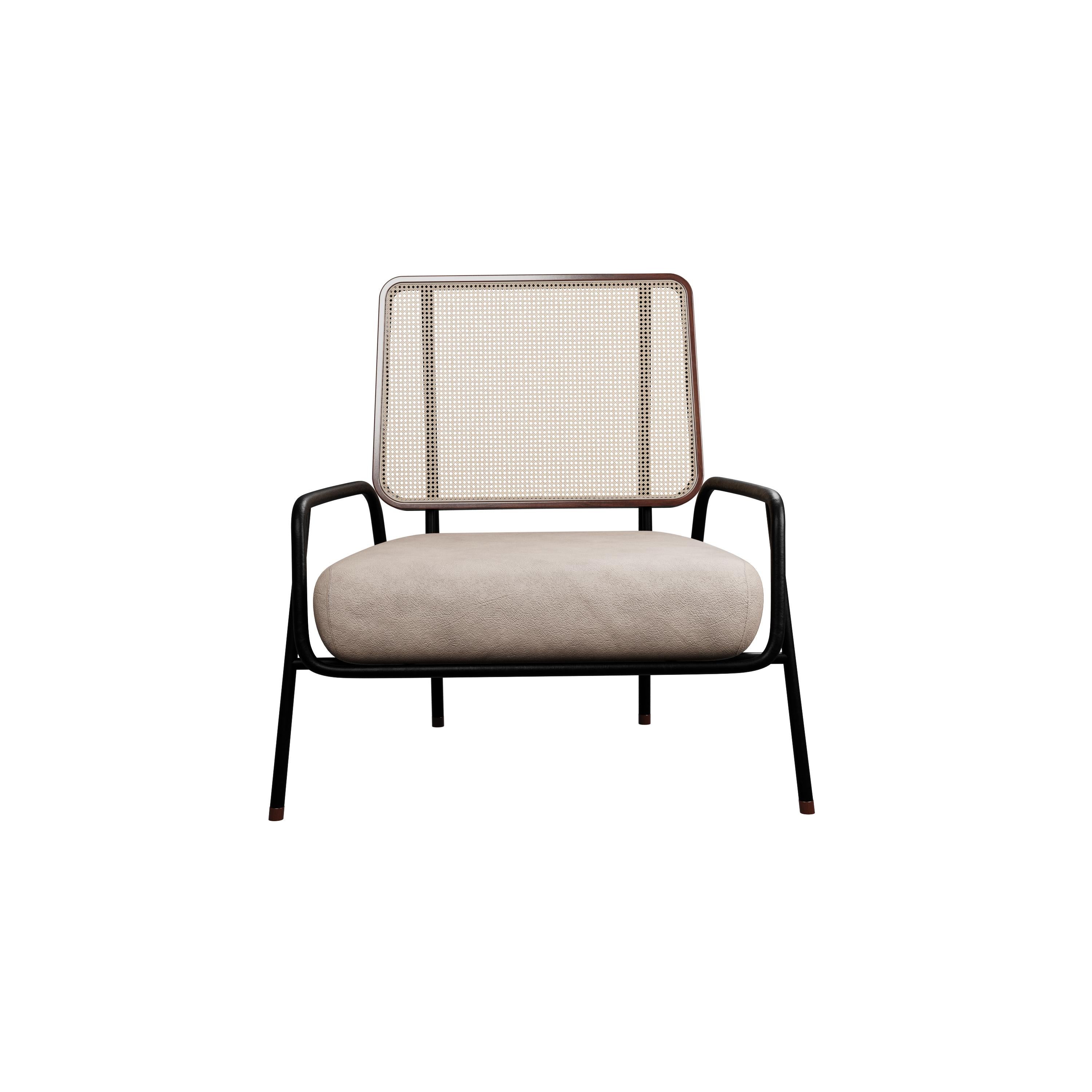 Murmurio's armchair with arm DUV sturdy iron structure provides a solid foundation, while the intricately woven rattan backrest, supported by an ashwood frame, adds a touch of natural beauty. The seat is upholstered in genuine leather, offering both