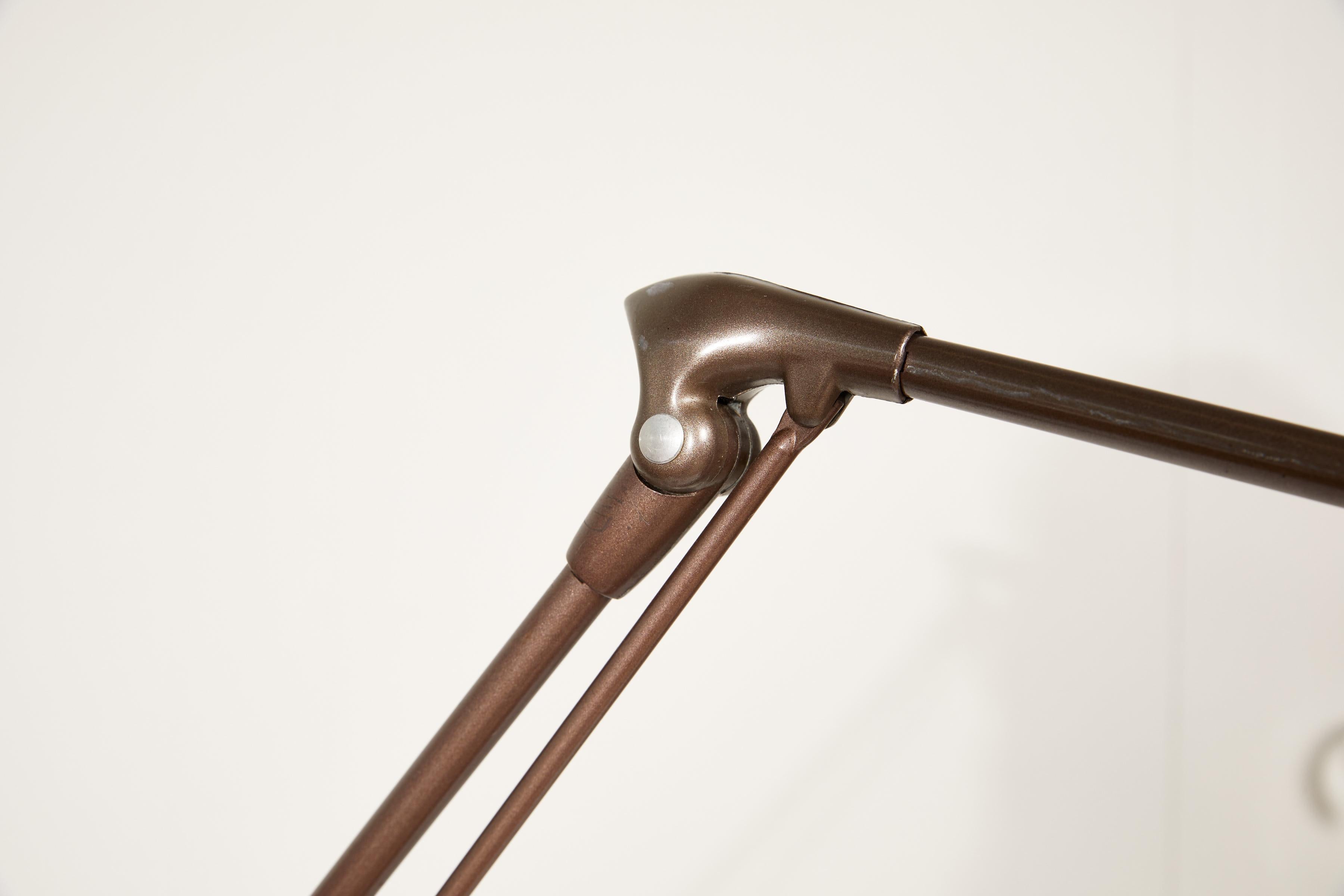 Midcentury industrial articulating single arm adjustable floor lamp in an enamel finish by Dazor.