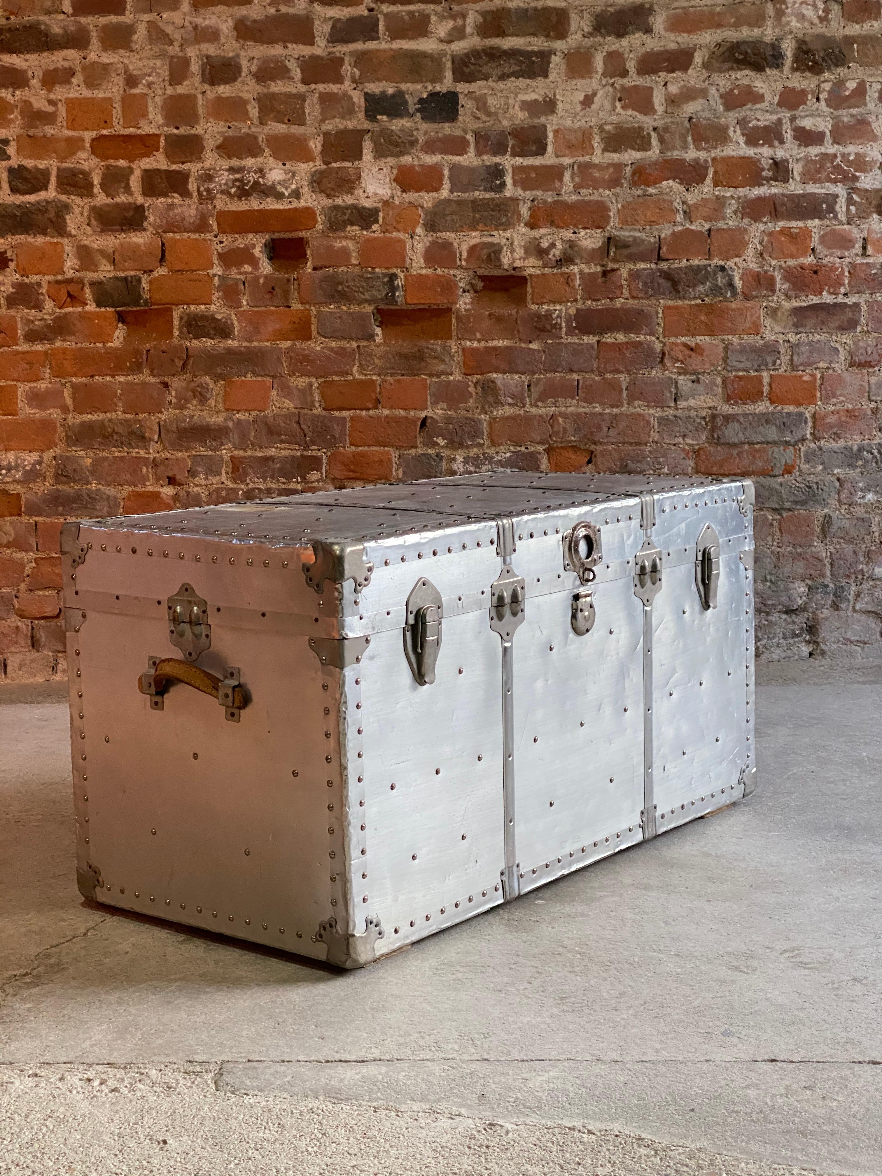 Industrial aviation aluminium travel trunk coffee table, circa 1940

Industrial aviation aluminium travel trunk circa 1940, a genuine travelling trunk with hinged lid, the trunk having studded outline and heavy locks and clasps, riveted all-over