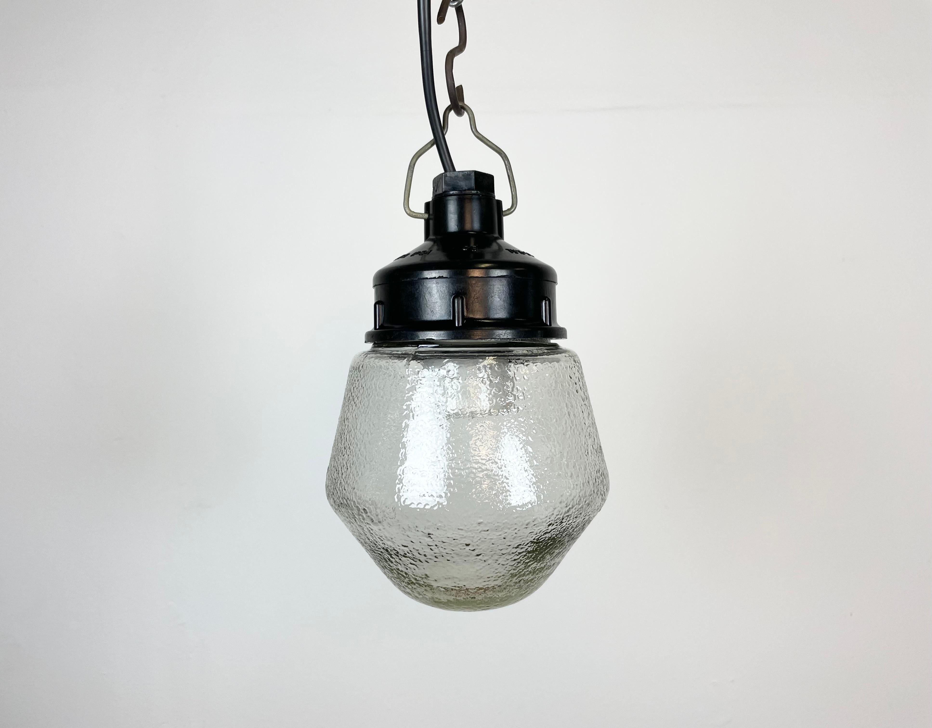 Vintage industrial light made in former Soviet Union during the 1970s. It features a brown bakelite top and a frosted glass cover. The socket requires E27 light bulbs. New wire. The weight of the lamp is 0,9 kg.