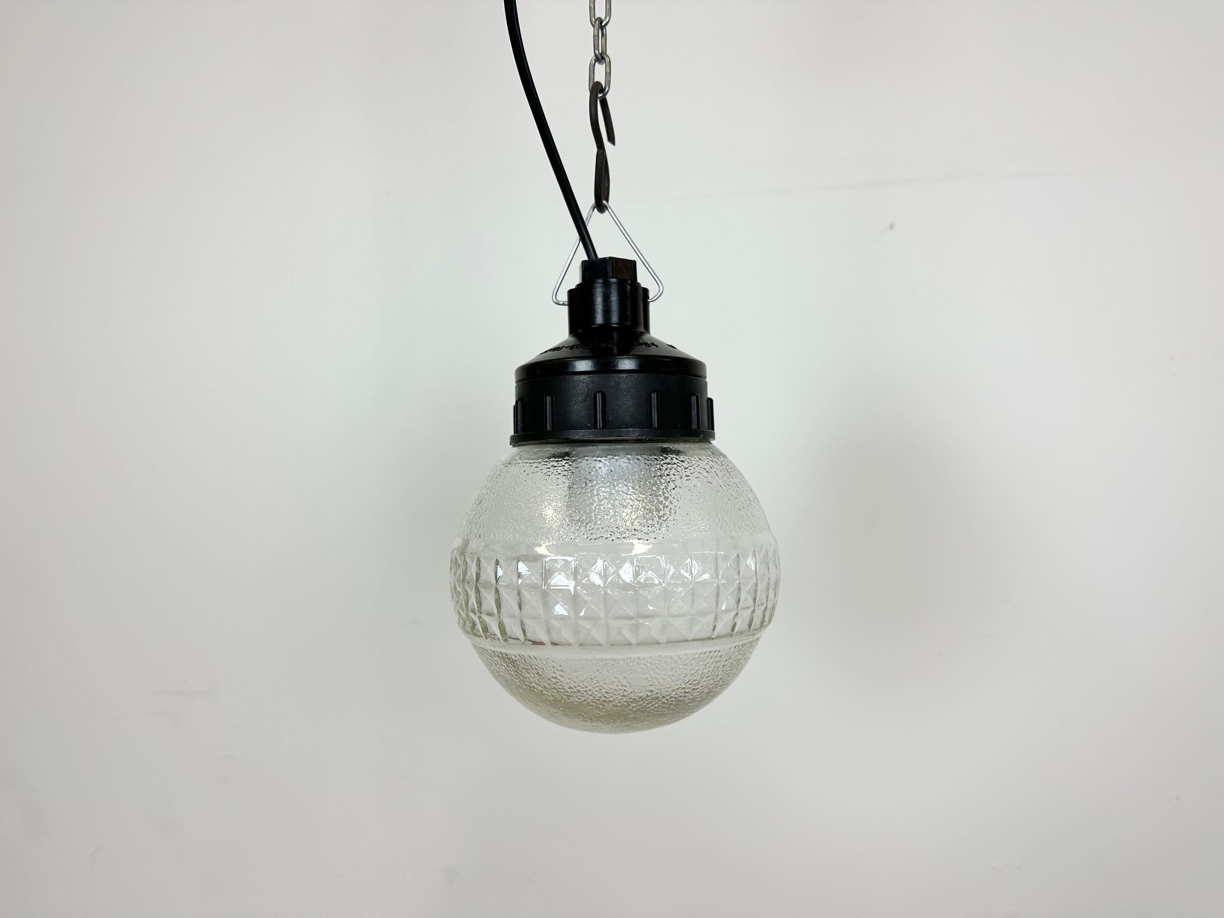 Vintage industrial light made in former Soviet Union during the 1970s. It features a brown bakelite top and a frosted glass cover. The socket requires E27/ E26 light bulbs. New wire. The weight of the lamp is 0,9 kg.
