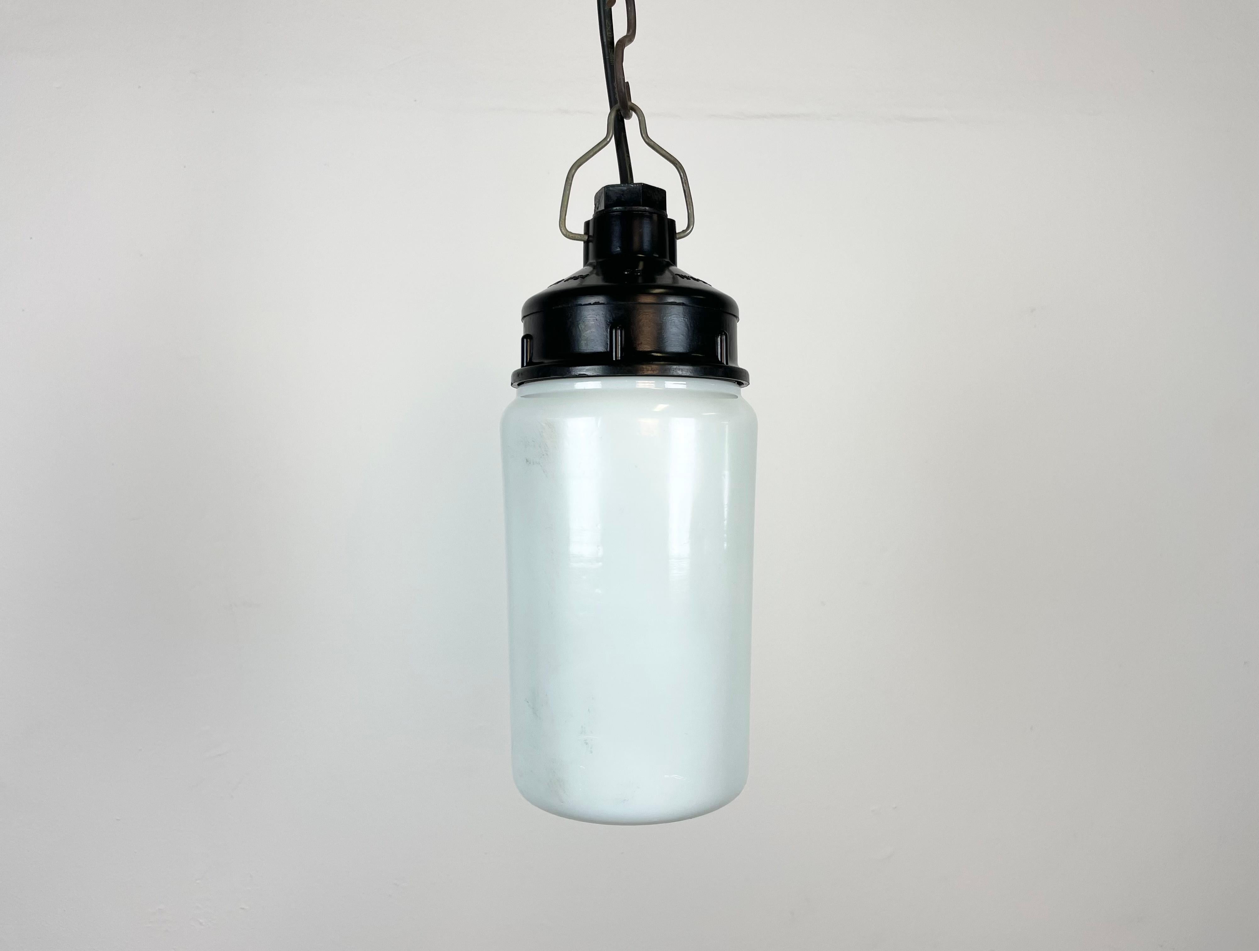 Vintage industrial light made in former Soviet Union during the 1970s. It features a brown bakelite top and a milk glass cover. The socket requires E27/E 26 light bulbs. New wire. The weight of the lamp is 0,85 kg.