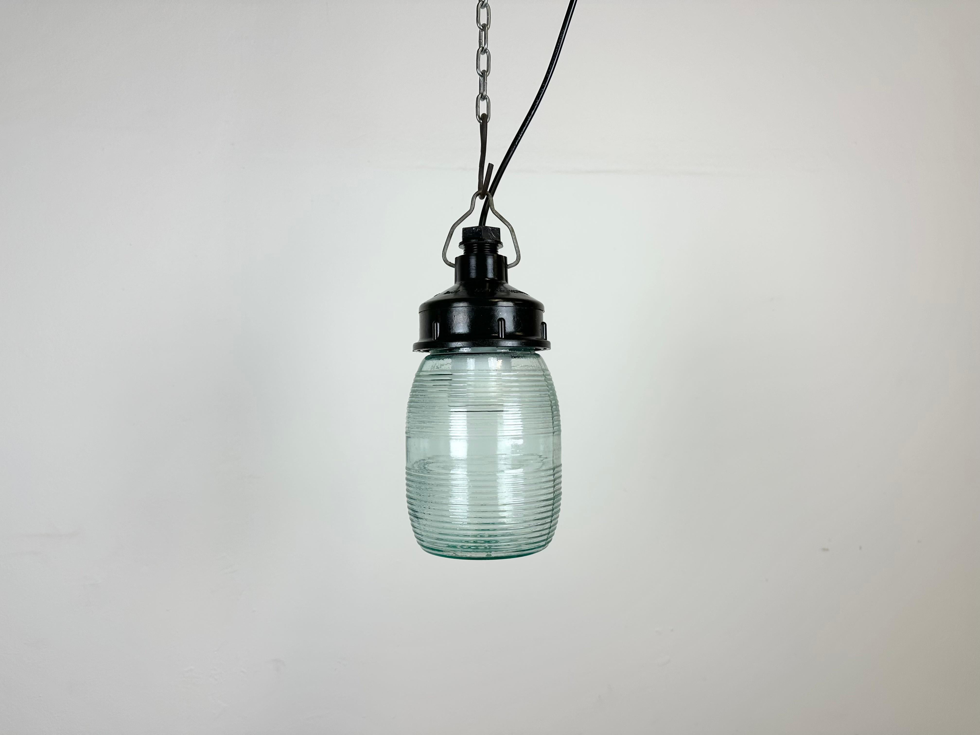 Vintage industrial light made in former Soviet Union during the 1970s. It features a brown bakelite top and a light green ribbed glass cover. The socket requires E27 / E26 light bulbs. New wire. The weight of the lamp is 0,8 kg.