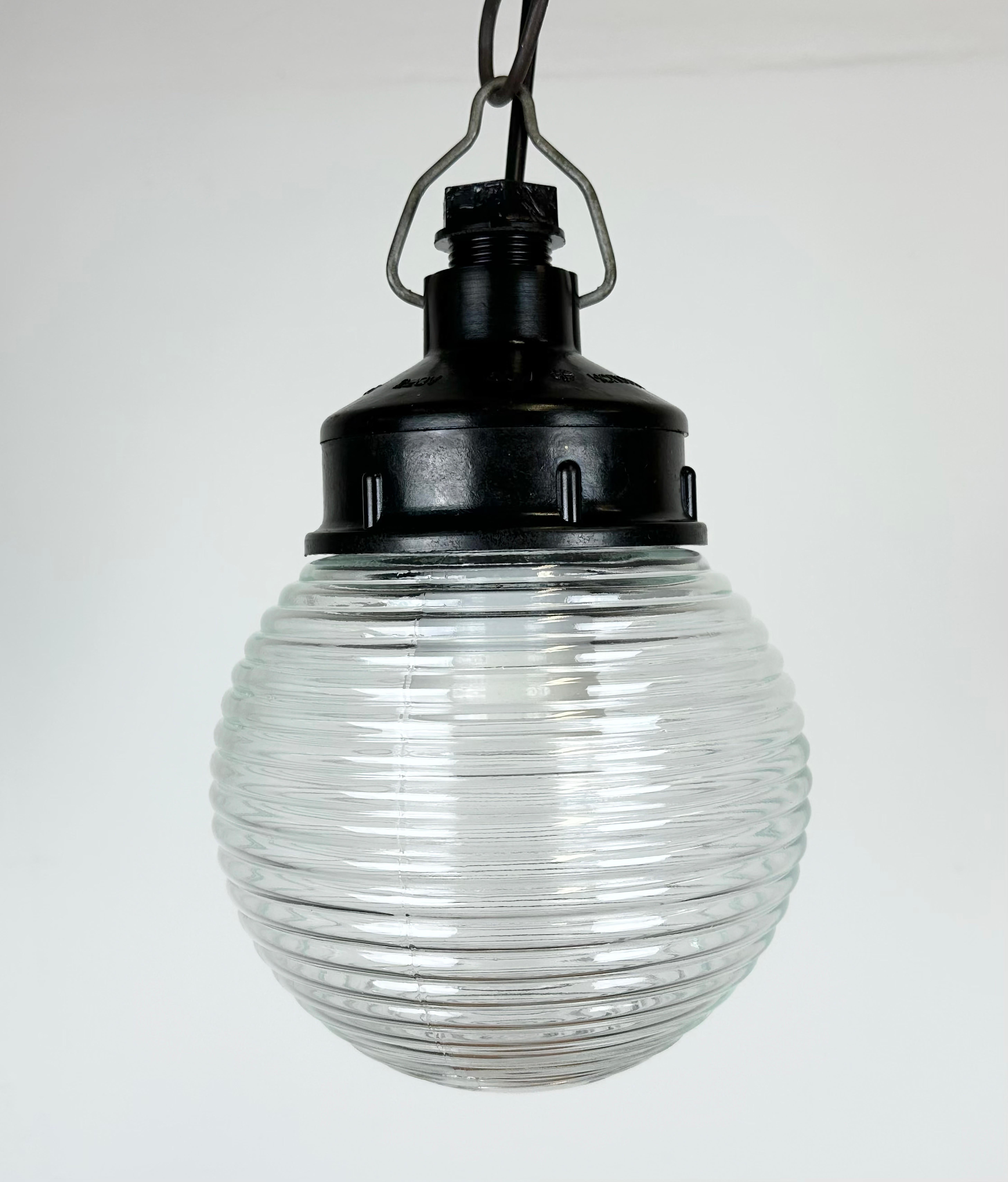Vintage industrial light made in former Soviet Union during the 1970s. It features a brown bakelite top and a ribbed glass cover. The socket requires E27 / E26 light bulbs. New wire. The weight of the lamp is 0,8 kg.