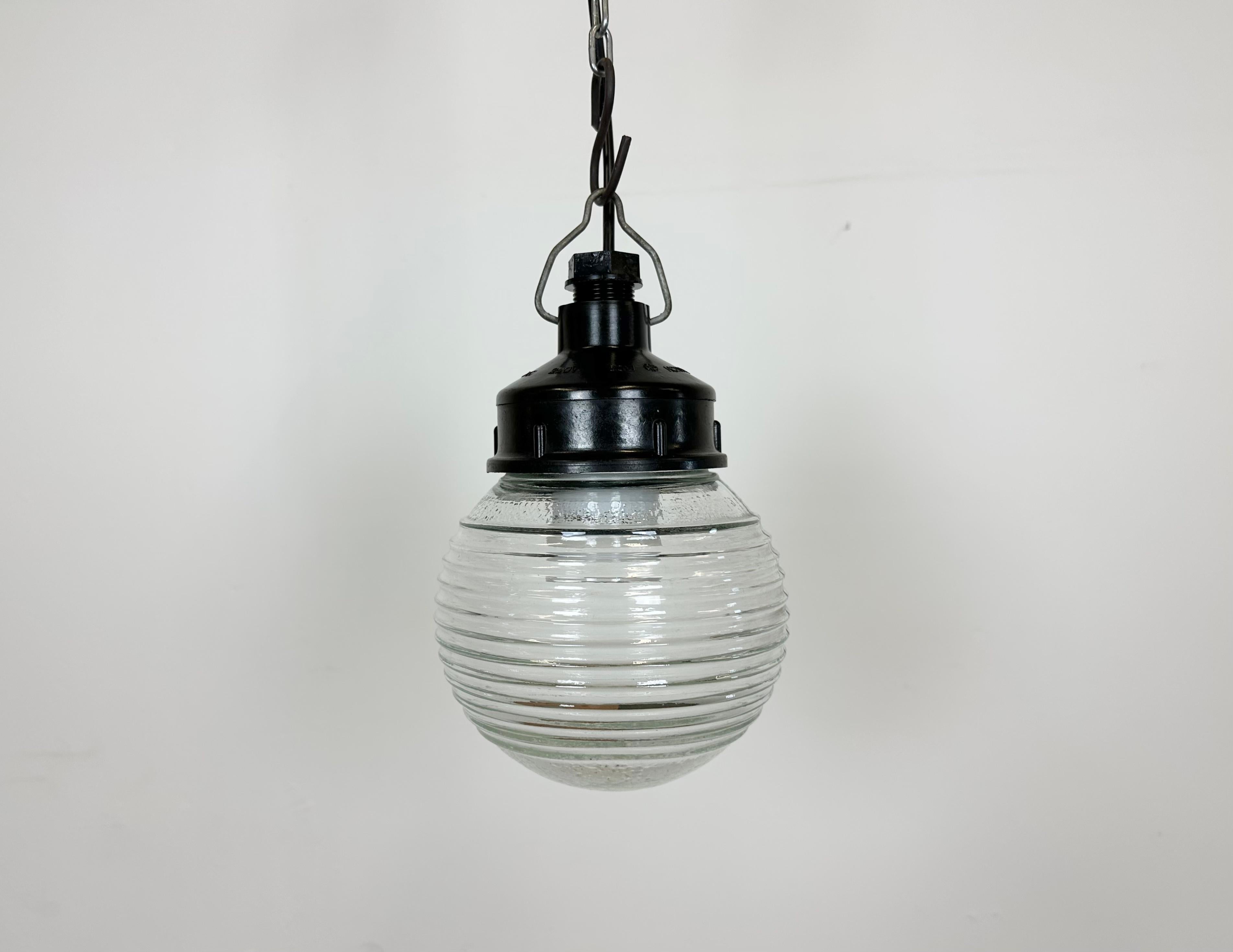 Vintage industrial light made in former Soviet Union during the 1970s. It features a brown bakelite top and a ribbed glass cover. The socket requires E27/ E26 light bulbs. New wire. The weight of the lamp is 0,9 kg.