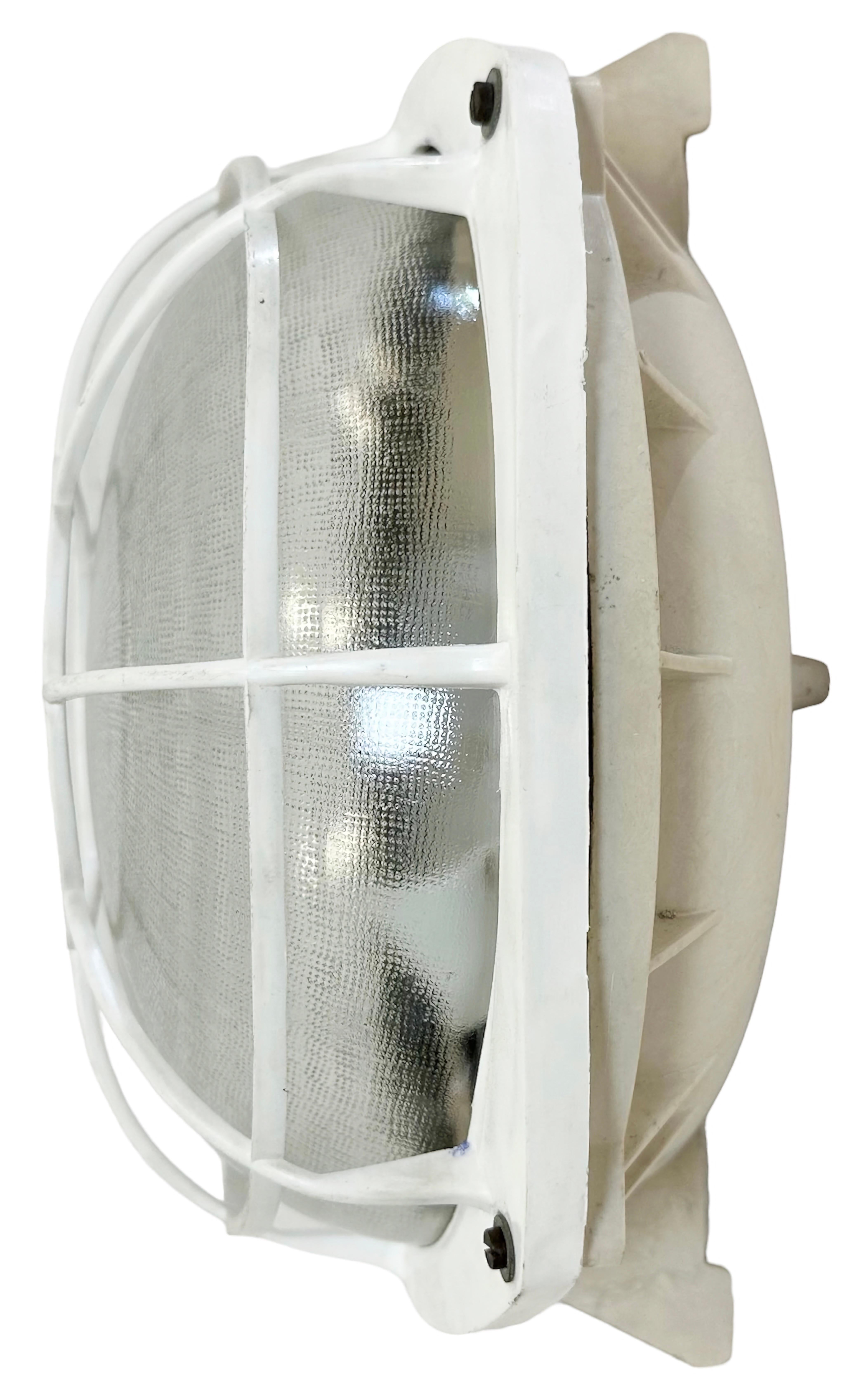 Vintage industrial white ( beige )bakelite wall lamp made by Elektrosvit in former Czechoslovakia during the 1980s. It features a bakelite body, a frosted curved glass cover and bakelite grid.The socket requires standard E 27 / E 26 light bulbs. It