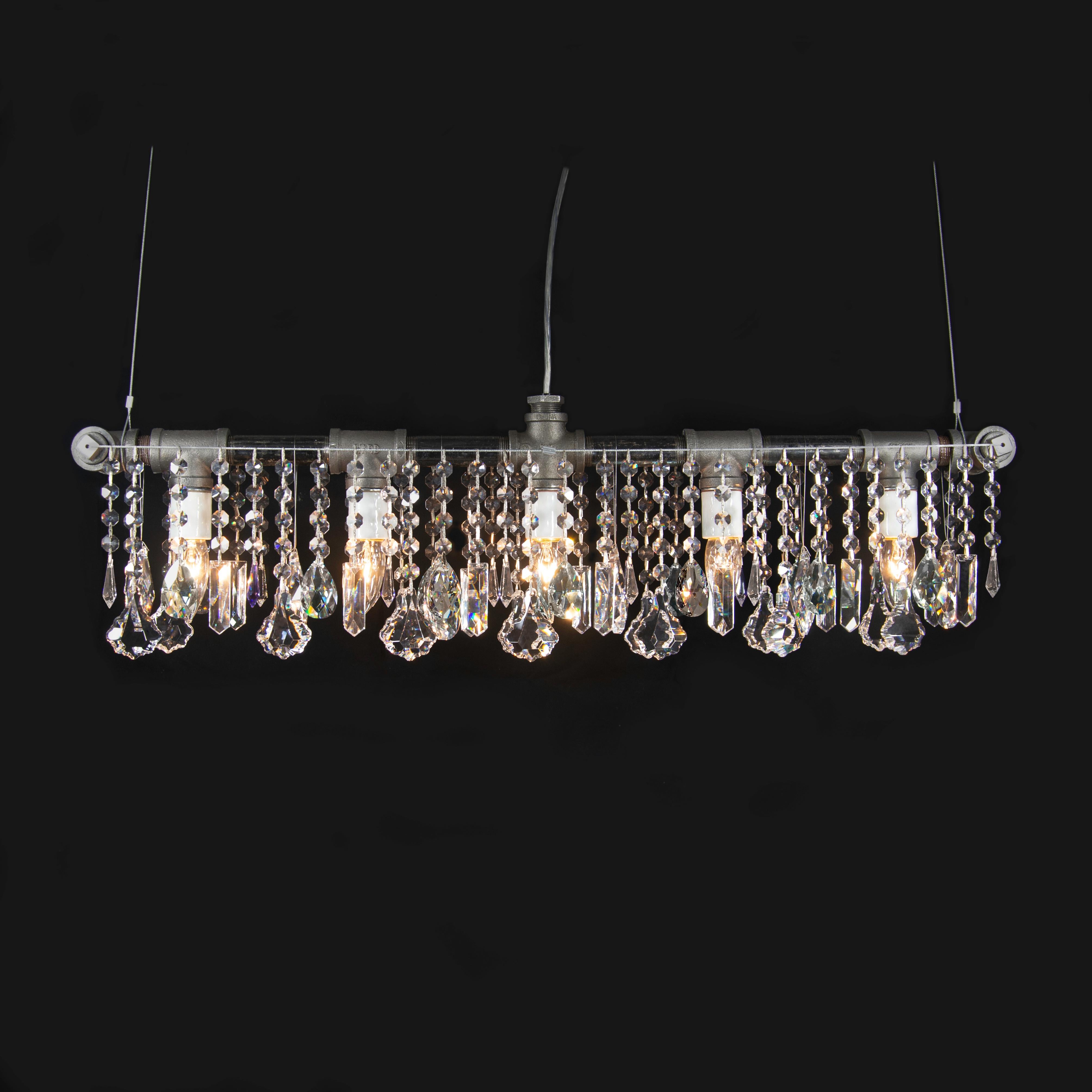 A Classic. This Industrial bar chandelier linear suspension features five porcelain sockets in a straight-line across a structure made of rough industrial pipes and fittings and flanked by curtains of super-high quality crystal, hanging from taut