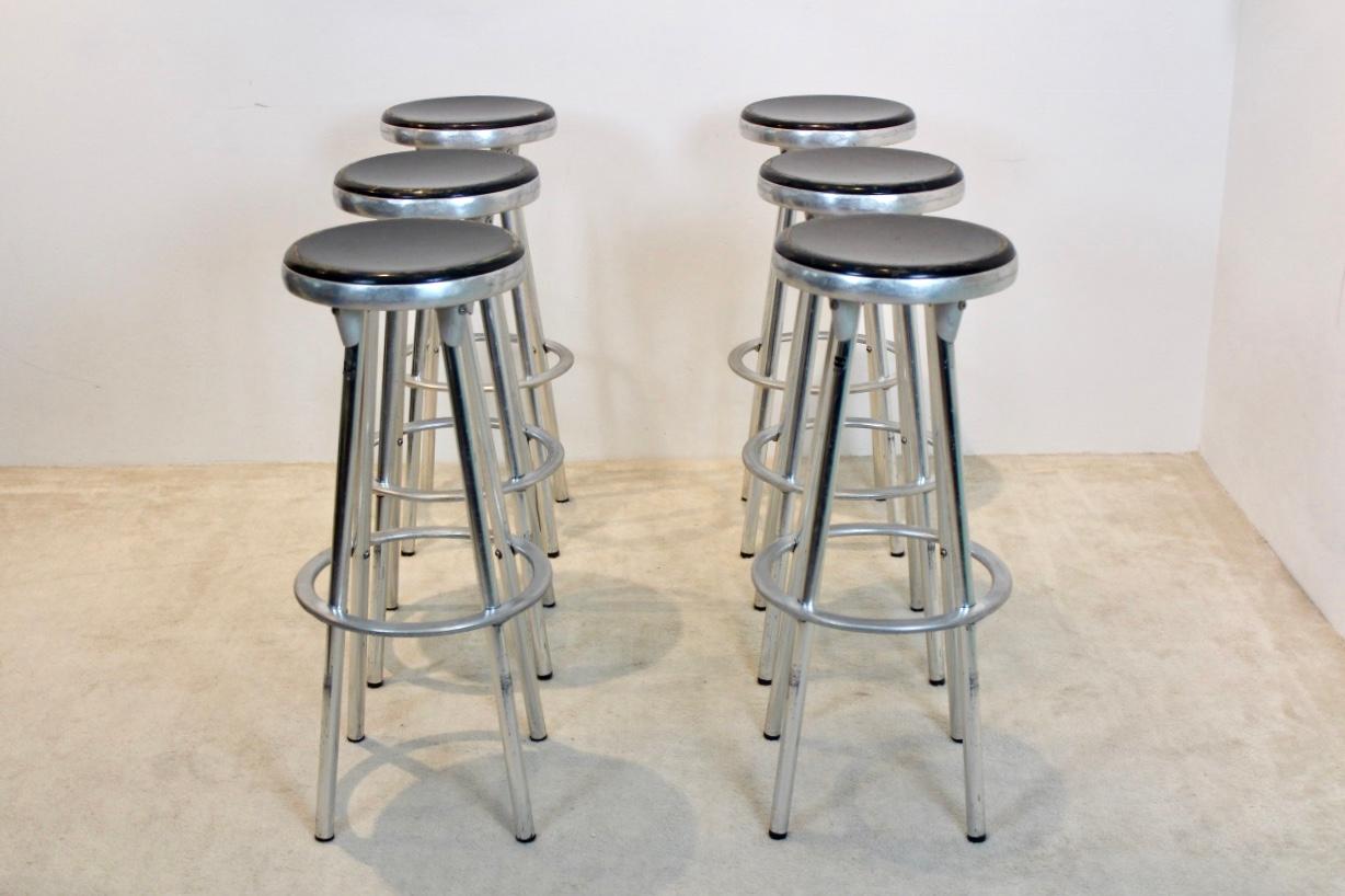 Set of six Industrial Bar Stools designed by Joan Casas I Ortinez for Indecasa, Barcelona Spain. This design has the feel of the Classic American counter stool with the added European flair. The stools combine the cast aluminum of the seat and