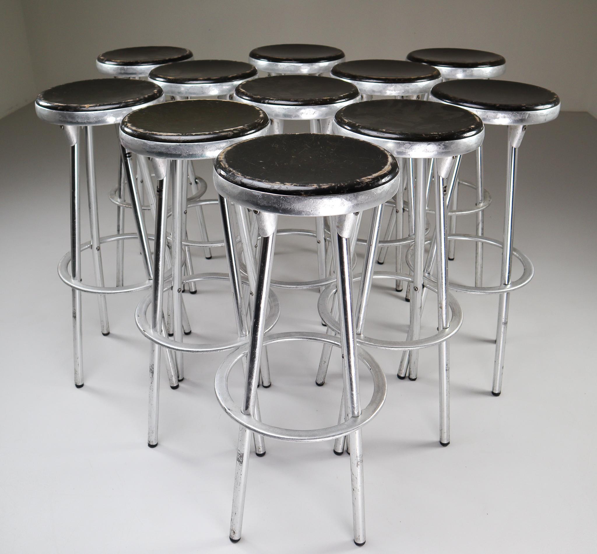 Large set of industrial bar stools designed by Joan Casas Y Ortinez for Indecasa, Barcelona, Spain. This design has the feel of industrial airport counter stool with the added European flair. The stools combine the cast aluminum of the seat and