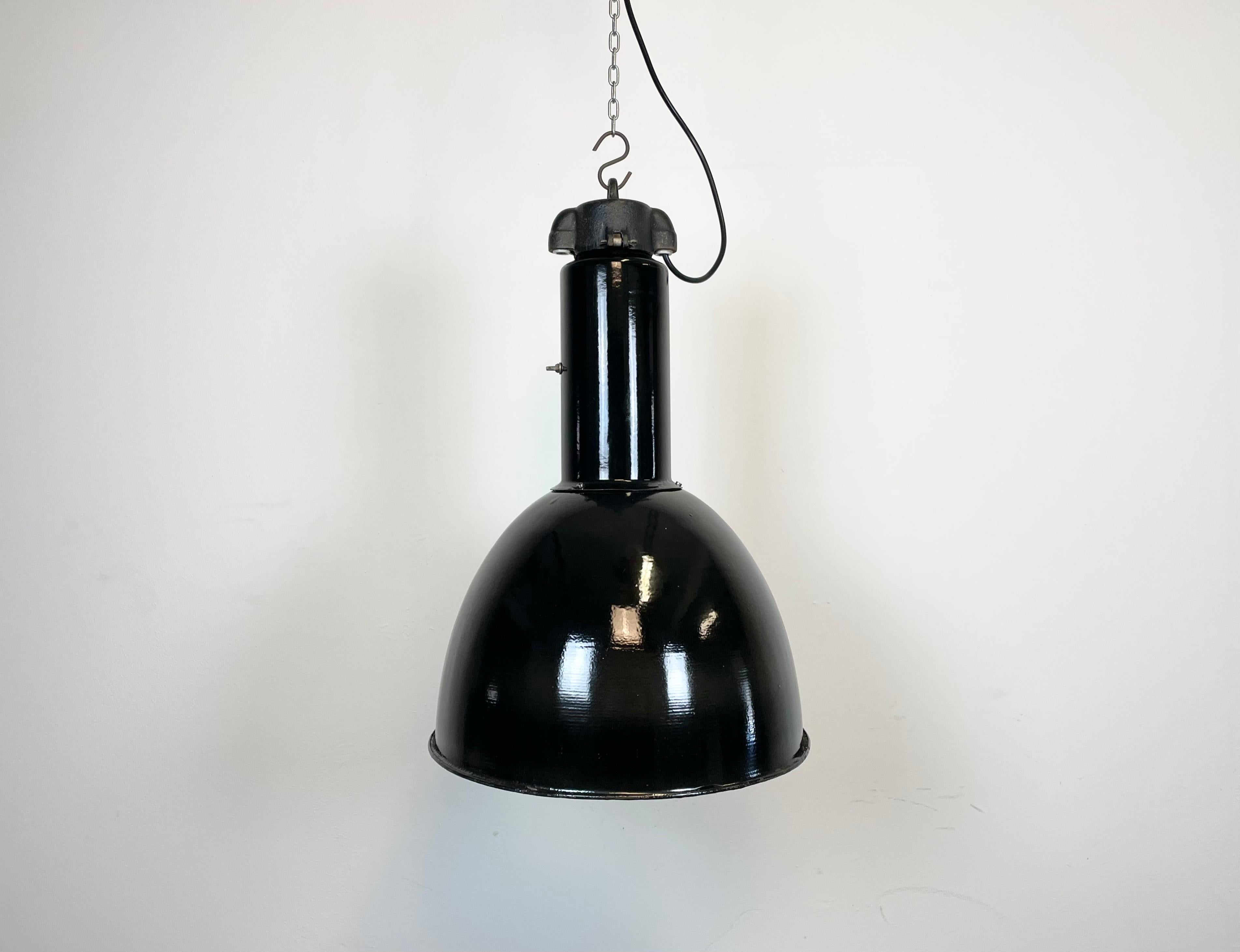 Industrial black enamel pendant lamp made by Elektrosvit in former Czechoslovakia during the 1930s -1970s. Designed in the period of Bauhaus. White enamel inside the shade. Cast iron top. New porcelain socket requires standard  E 27/ E 26