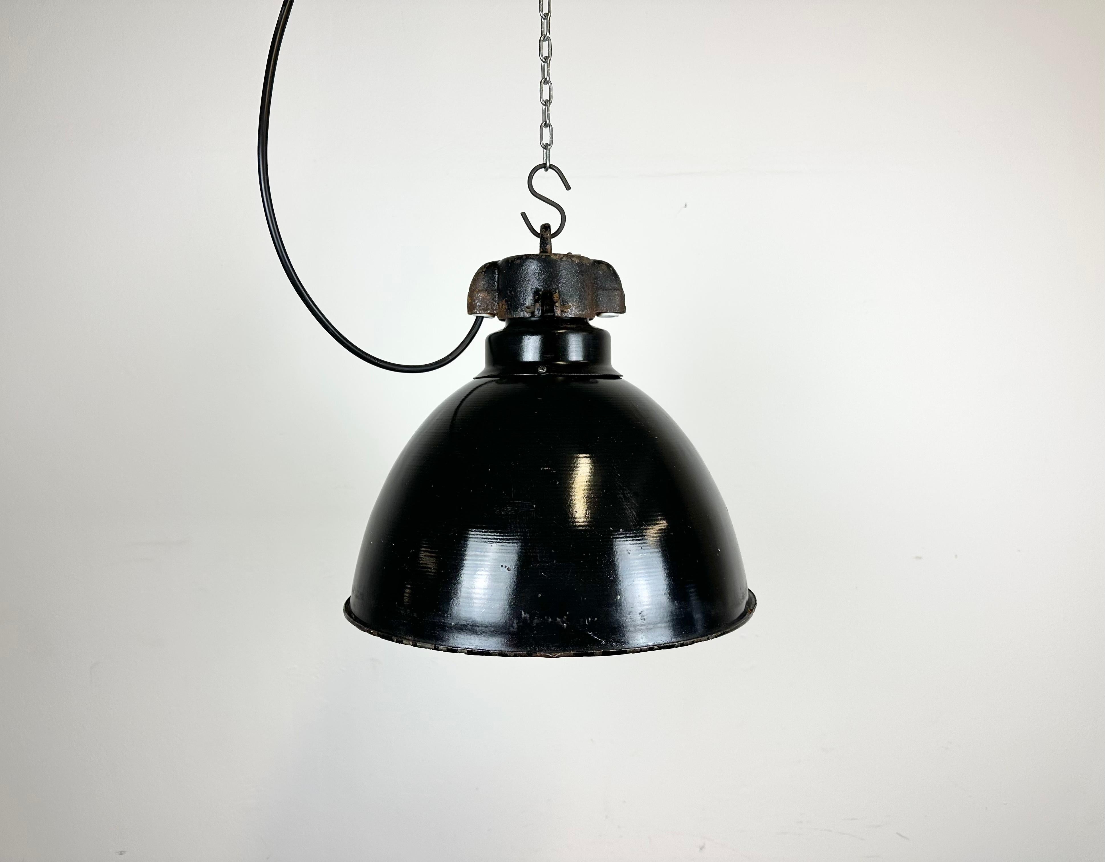 Industrial black enamel pendant light made by Elektrosvit in former Czechoslovakia. Designed in the period of Bauhaus. White enamel inside the shade. Cast iron top. New porcelain socket for E 27/ E26 lightbulbs and wire. Fully functional. The weight