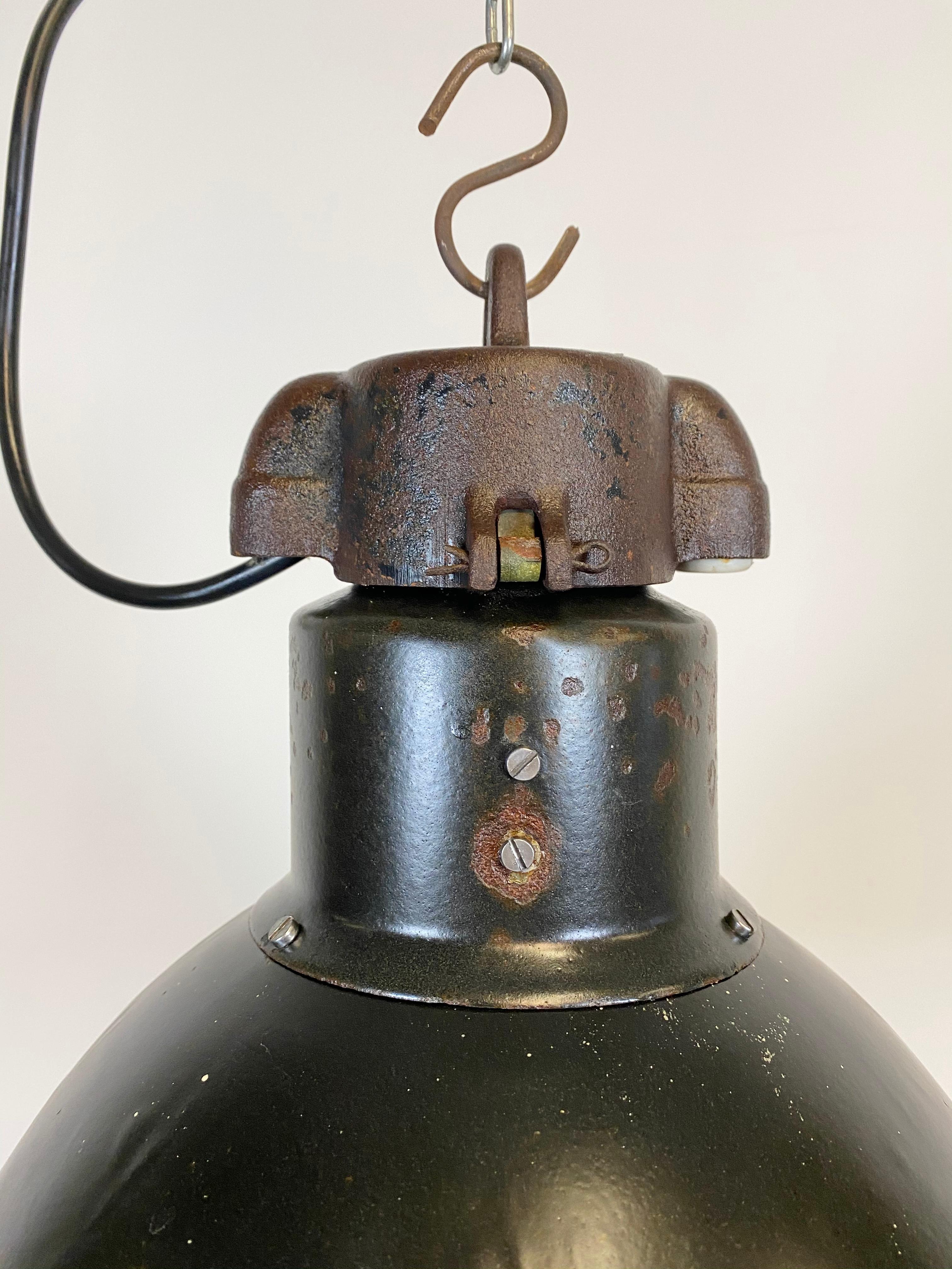 - Vintage Industrial black enamel pendant lamp
- Designed in the period of Bauhaus, 1930s 
- White enamel inside the shade 
- Cast iron top 
- New porcelain socket for E 27 lightbulbs and wire
- Diameter 34 cm, weight 3 kg.