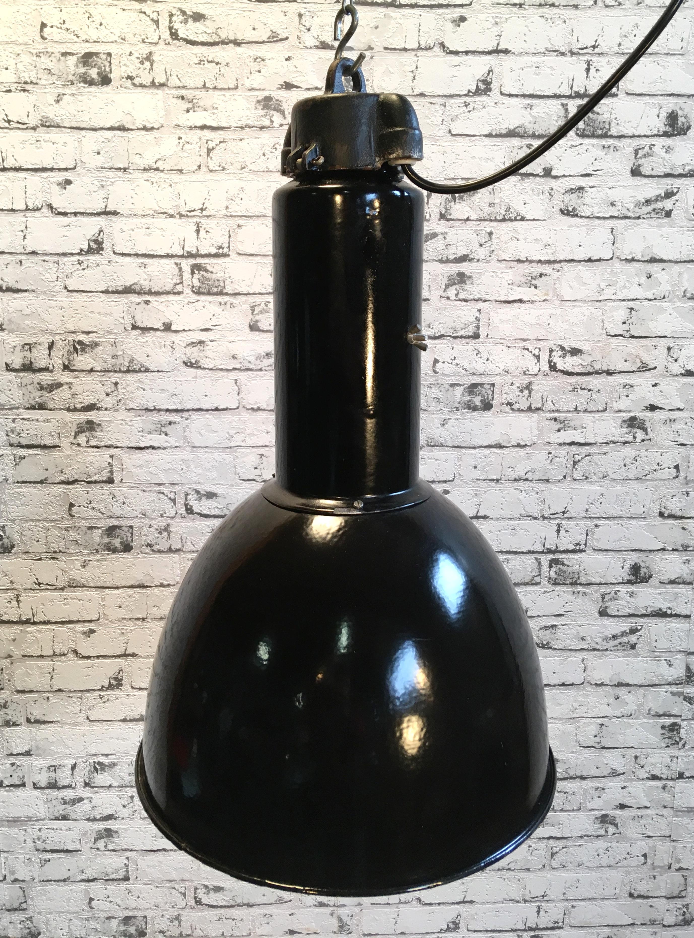 Industrial black enamel pendant lamp from former Czechoslovakia . Designed in the period of Bauhaus.  White enamel inside the shade. Cast iron top. New porcelain socket for E 27 lightbulbs and wire. Fully functional.