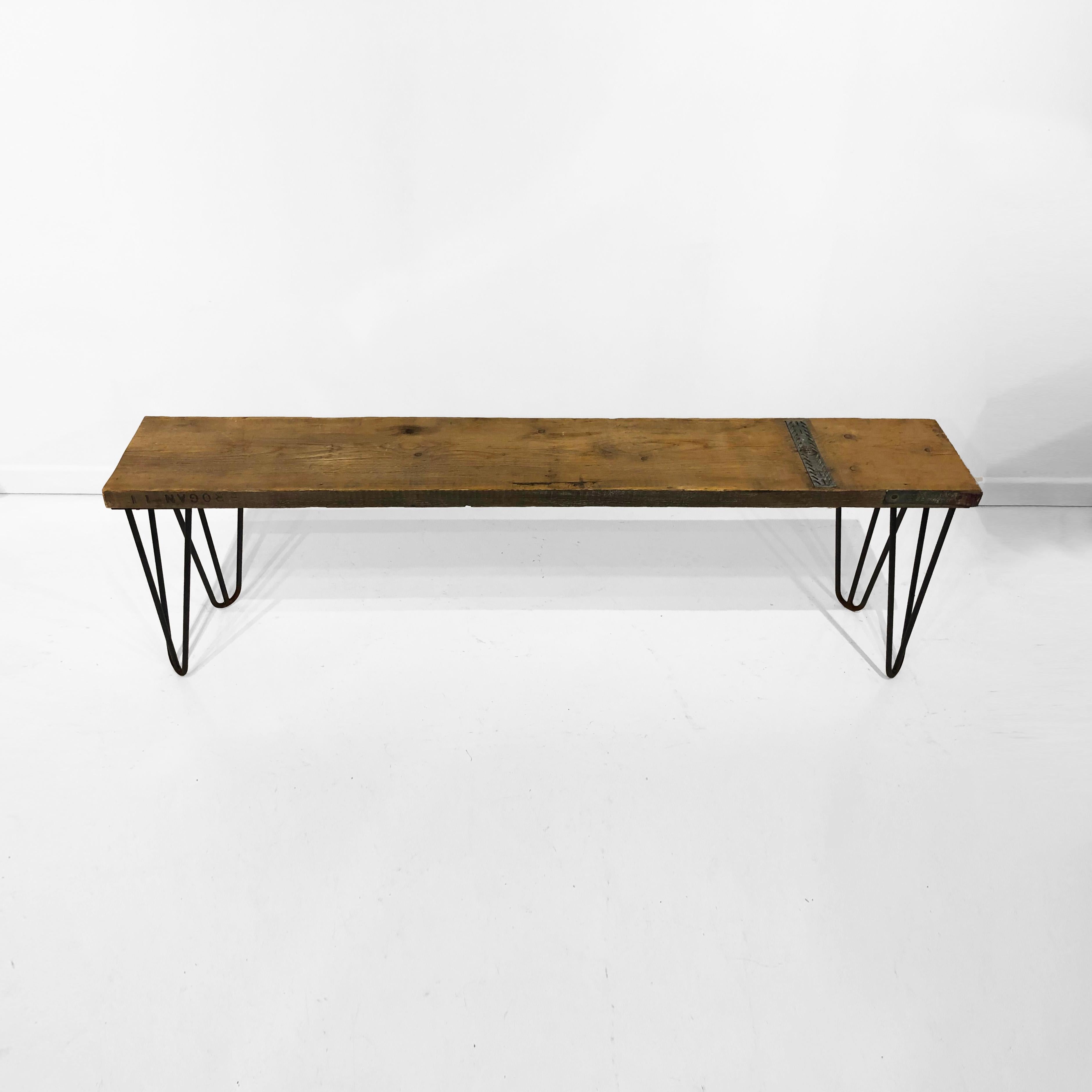 Early 21st century industrial bench made out of scaffolding wood and hairpin legs. Industrial midcentury inspired, it would look perfect either indoors or outdoors as its weather resistant. The bench has embossed manufacturers letters with nice
