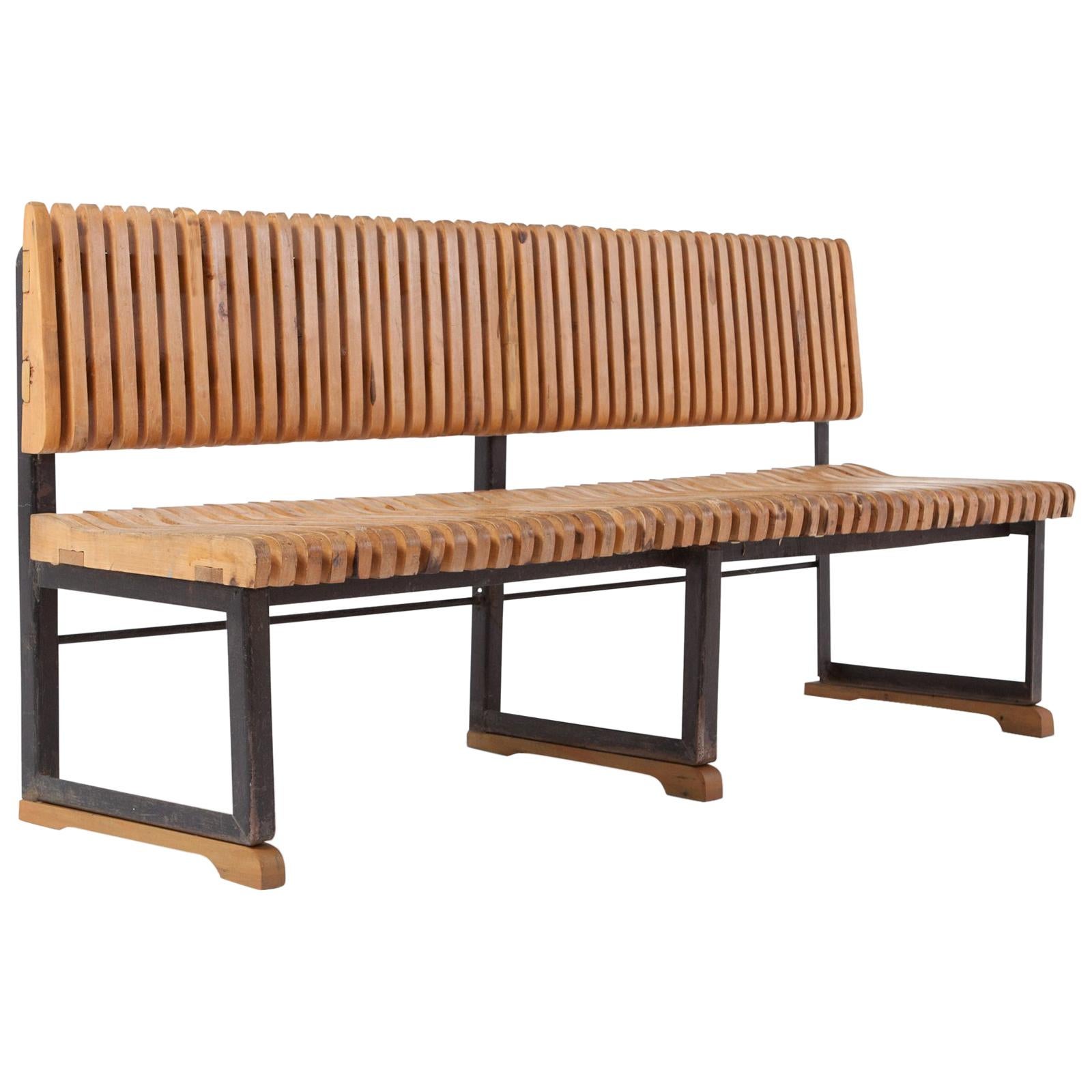 Midcentury bench, Dutch design from the 1960s

Slatted bench in solid pine with a black lacquered steel frame. The bench show multiple marks of wear consistent with age and use, giving it a lot of character and a very robust and impressive