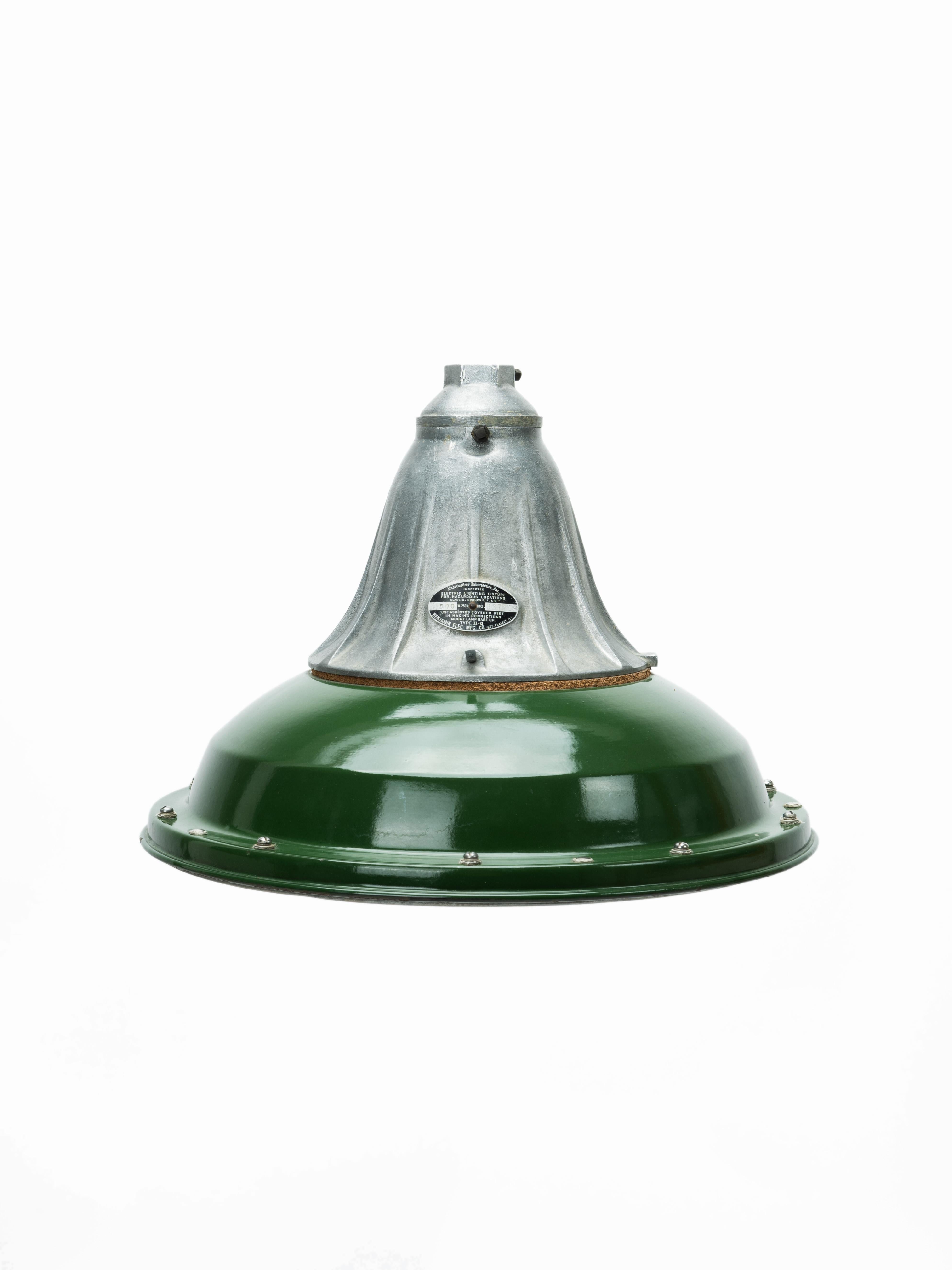 Excellent example of early Industrial American engineering, the Benjamin Electrical Company's 'Explosion Proof' light fixture is a perfect piece of antique lighting. Sporting a cast iron shroud, green enameled shade and thick glass bezel, this piece