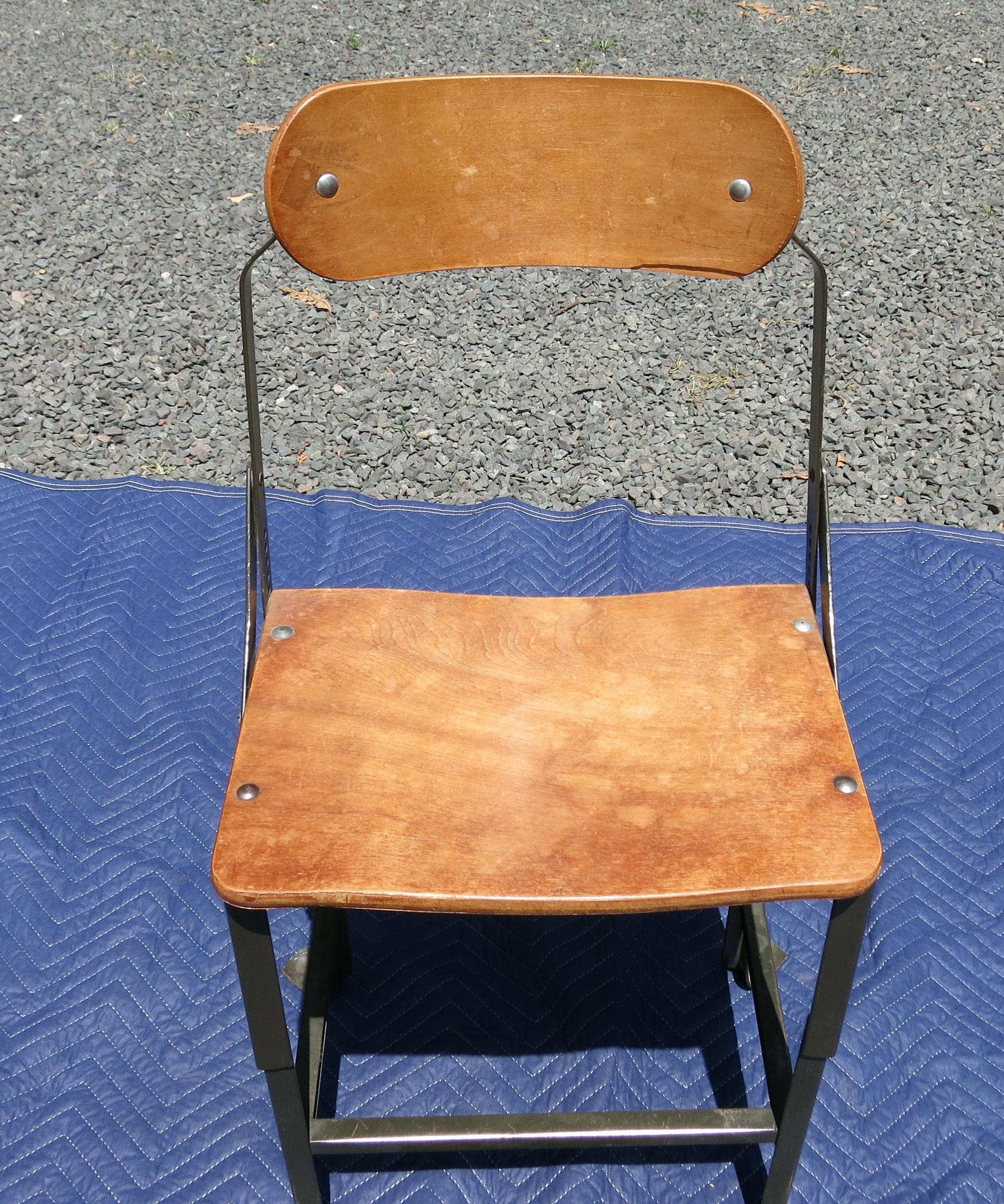 Industrial Bent plywood adjustable chair. Some veneer loss and separation. It is 33.5