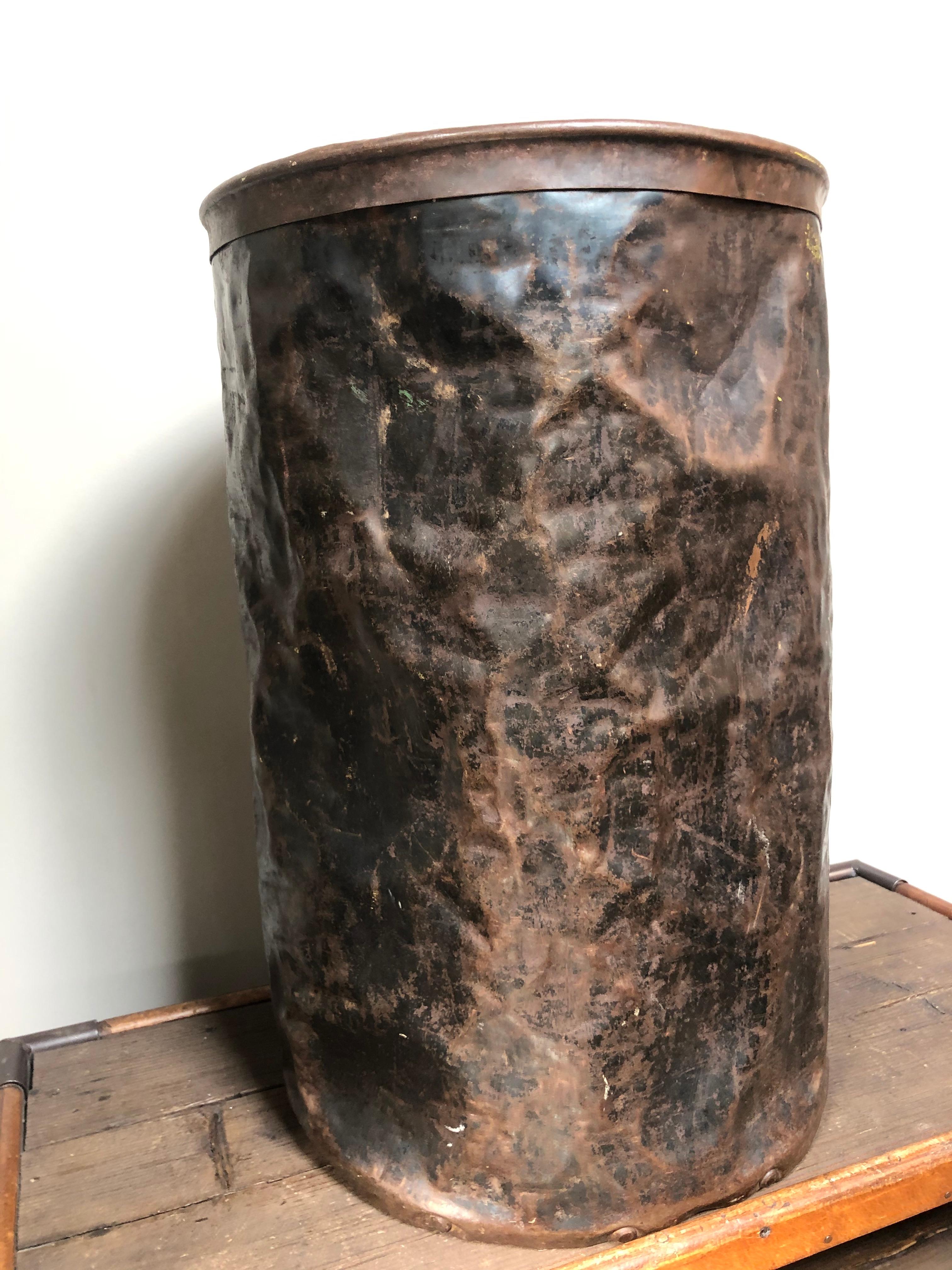 Industrial bin in metal with a bronze like hammered patina.